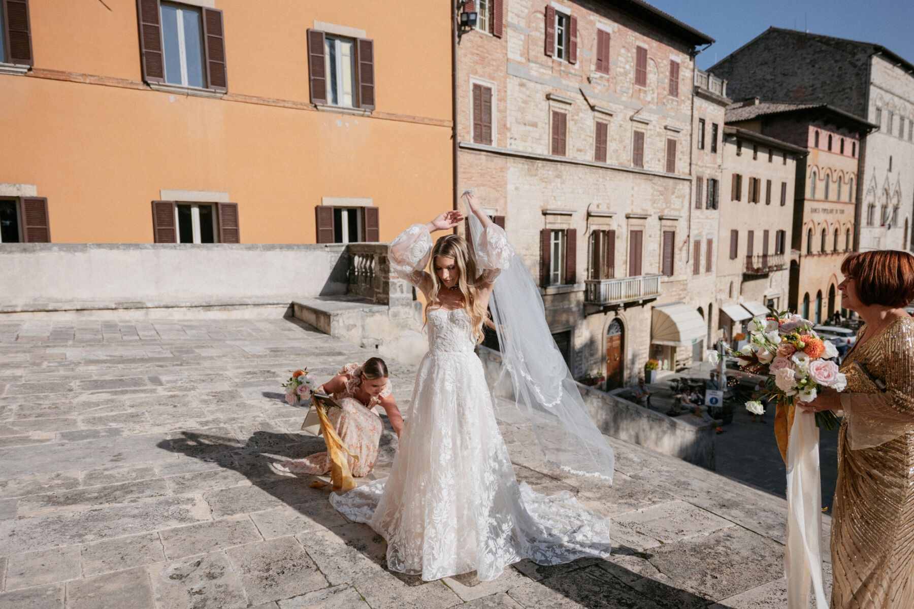 Mikaela in Alena Leena For Her Elegant Italian Wedding at Villa Fattoria di Vibio 24 Bride in an Alena Leena wedding dress getting herself ready before entering the church for her Italian wedding ceremony. Photography by Stefano Santucci.