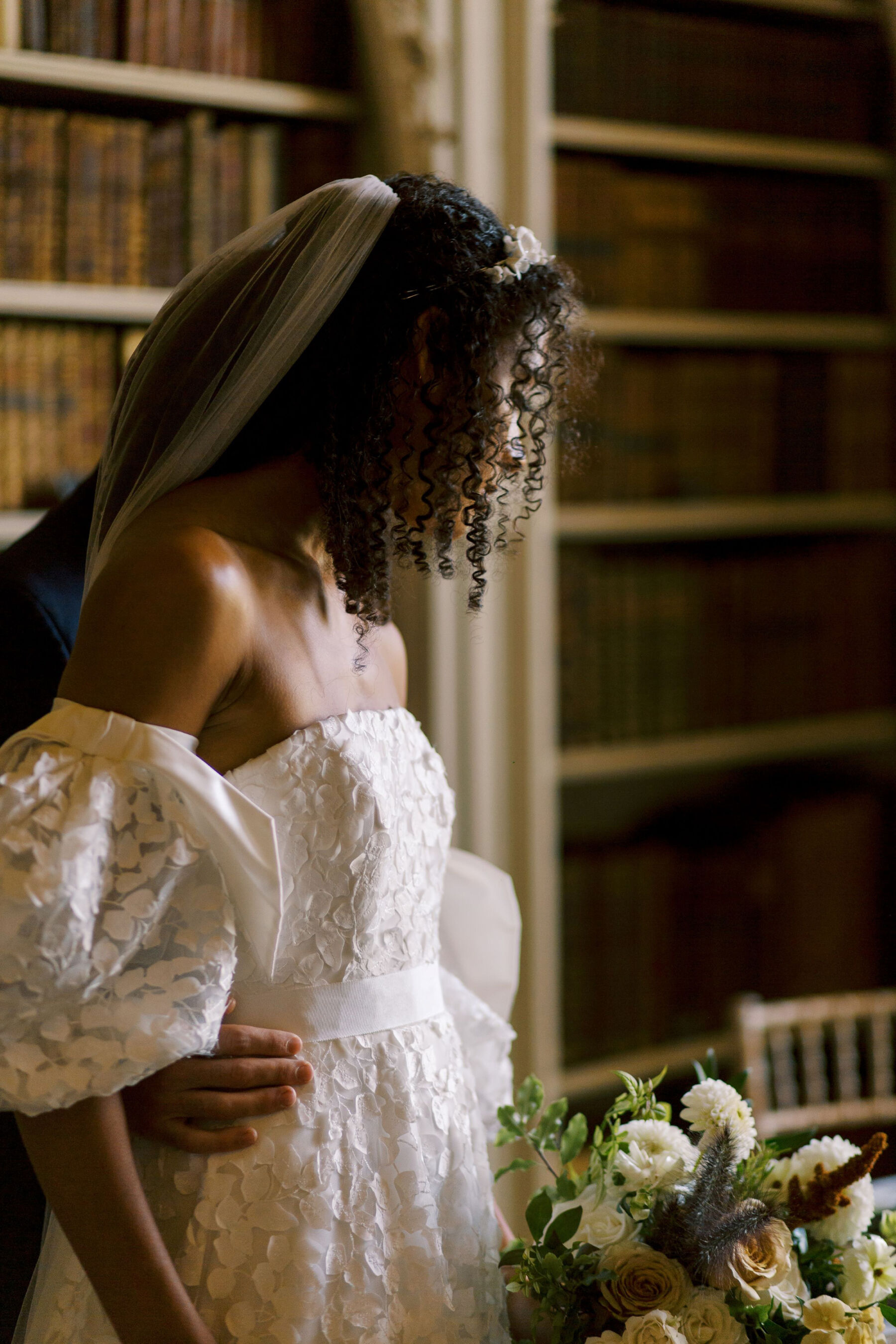 Gothic Architecture Inspired Wedding Styling, at Strawberry Hill House 20 Black modern bride with natural curly afro hair, wears a puff sleeve wedding dress by Sassi Holford. Helen Warner Photography.