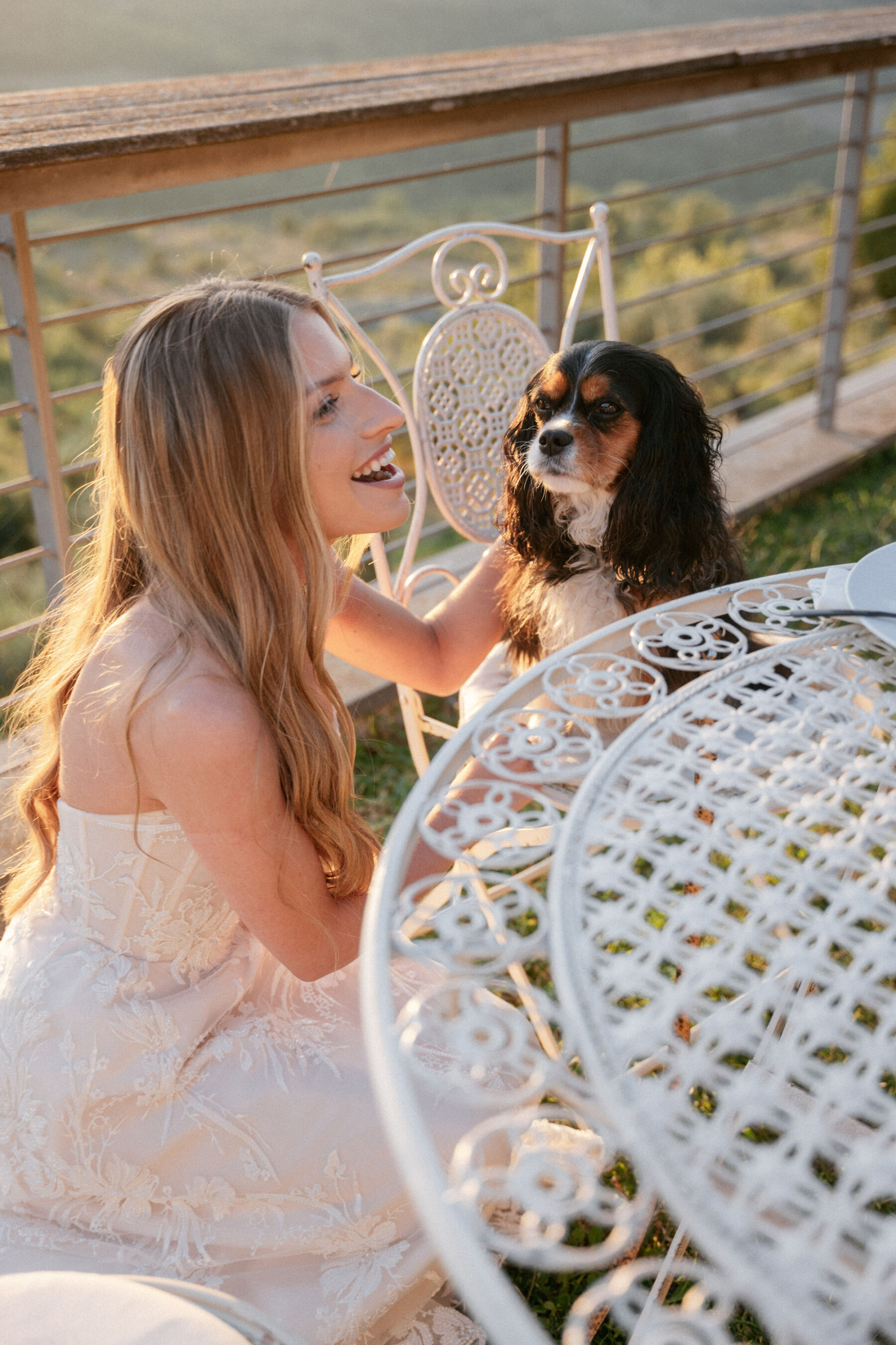 Mikaela in Alena Leena For Her Elegant Italian Wedding at Villa Fattoria di Vibio 42 Bride is kneeling to stroke her dog. Photography by Stefano Santucci.
