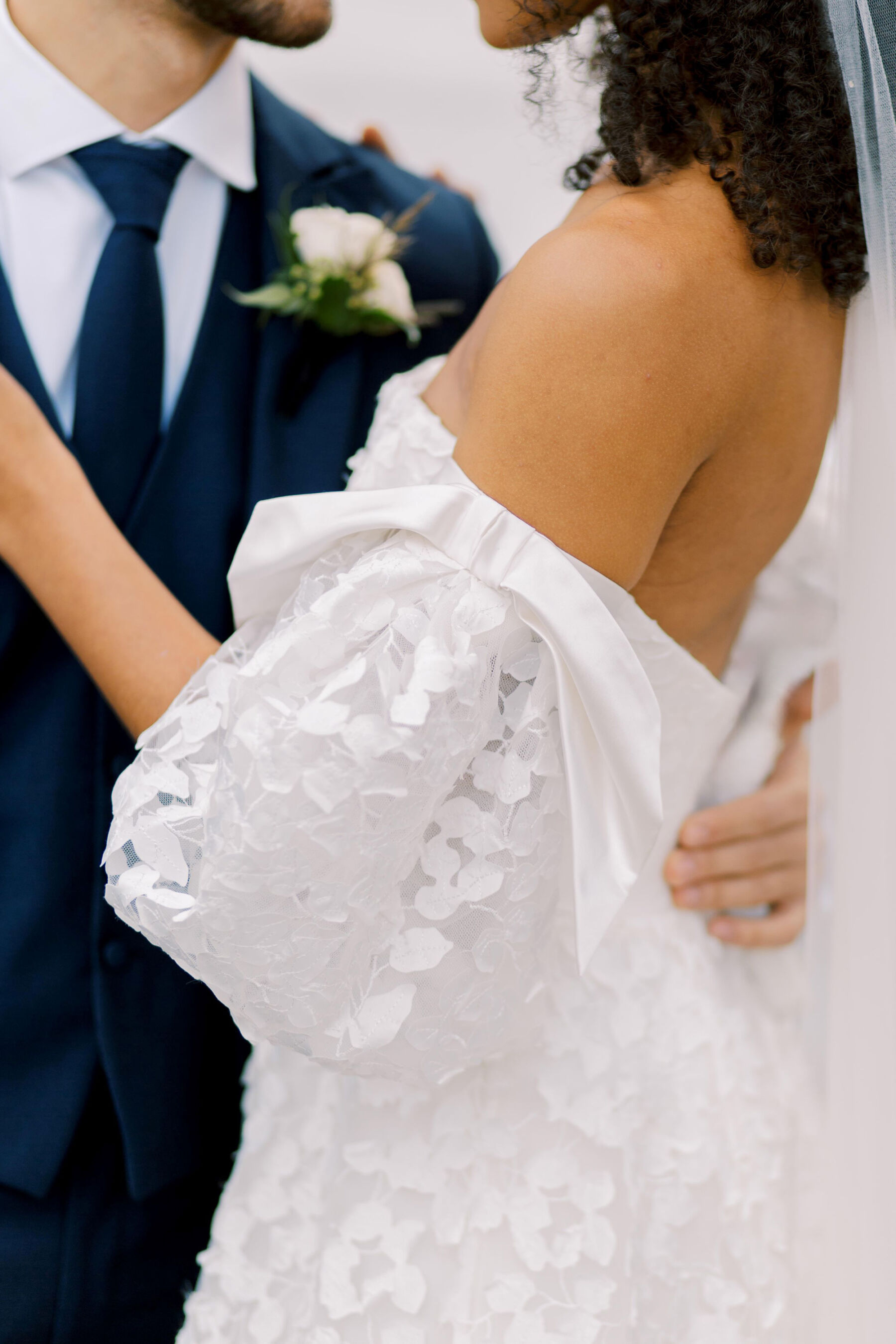 Gothic Architecture Inspired Wedding Styling, at Strawberry Hill House 22 Close up, faceless shot of bride and groom embracing. Bride wears a puff sleeve wedding dress by Sassi Holford. Helen Warner Photography.