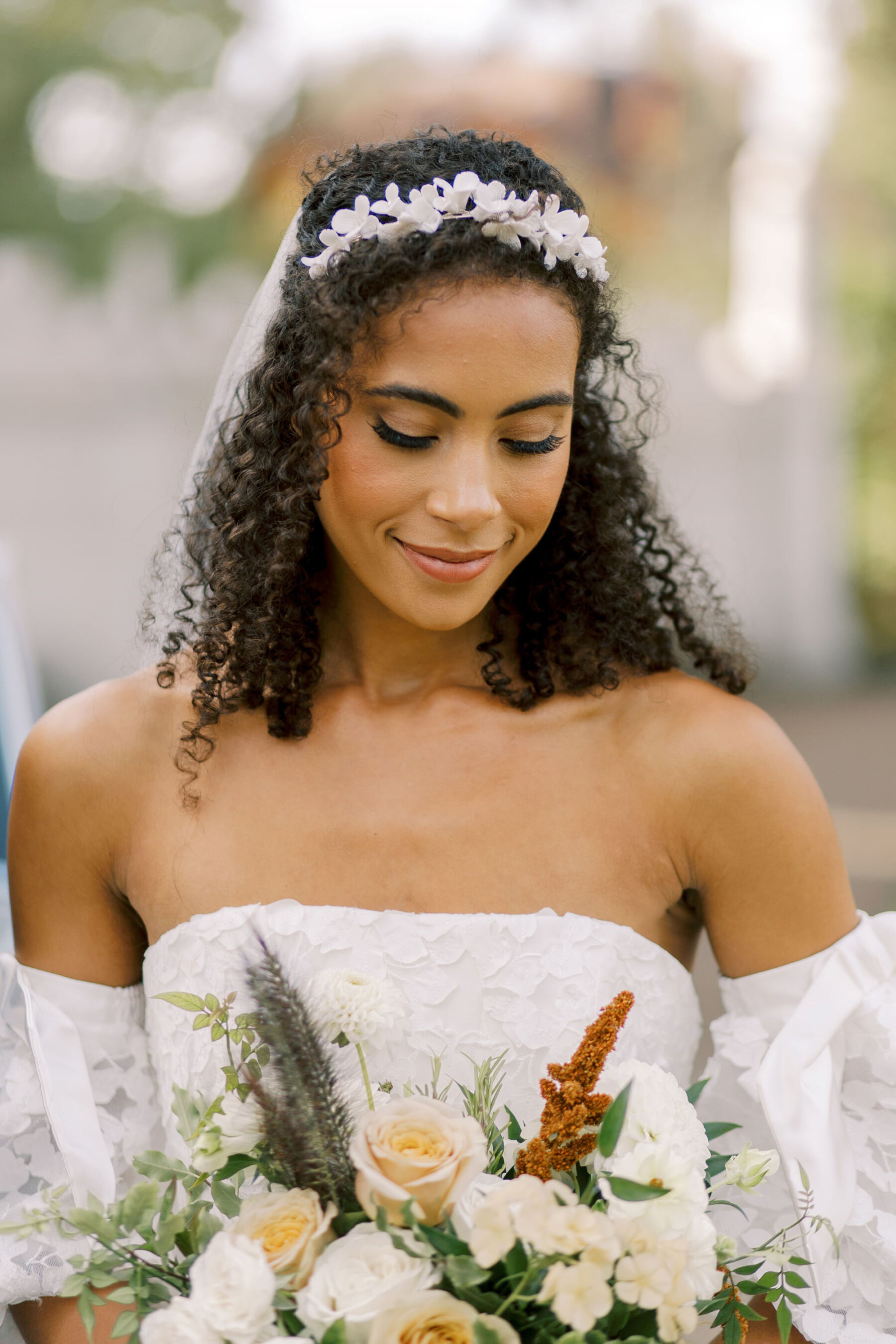 Gothic Architecture Inspired Wedding Styling, at Strawberry Hill House 24 Elegant Black bride with natural curly afro hair looks down towards the hand-tied wedding bouquet she is holding to her chest. Helen Warner Photography.