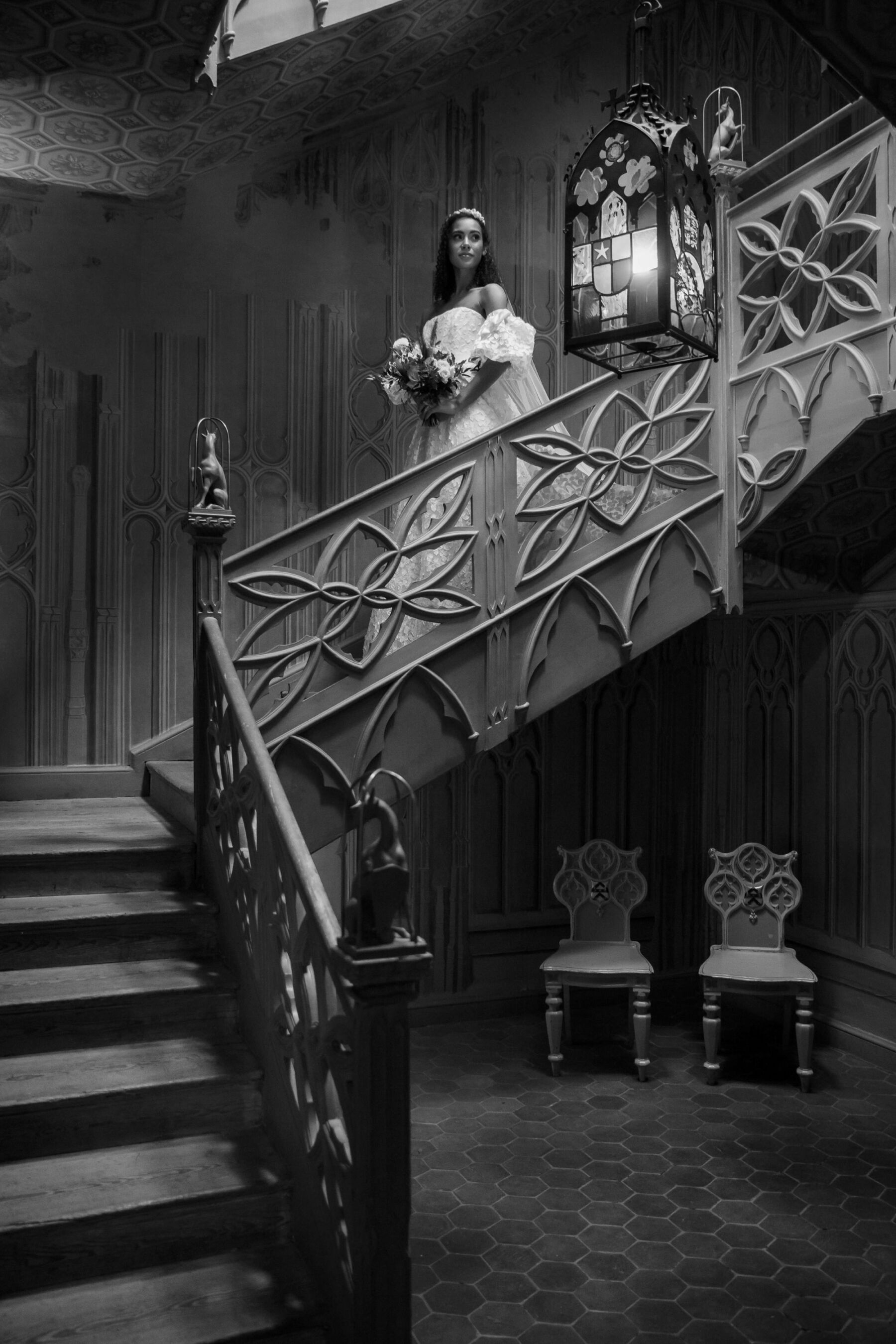 Gothic Architecture Inspired Wedding Styling, at Strawberry Hill House 8 An elegant bride in a puff sleeved wedding dress by Sassi Holford descends the carved wooden staircase at Strawberry Hill House. Helen Warner Photography.