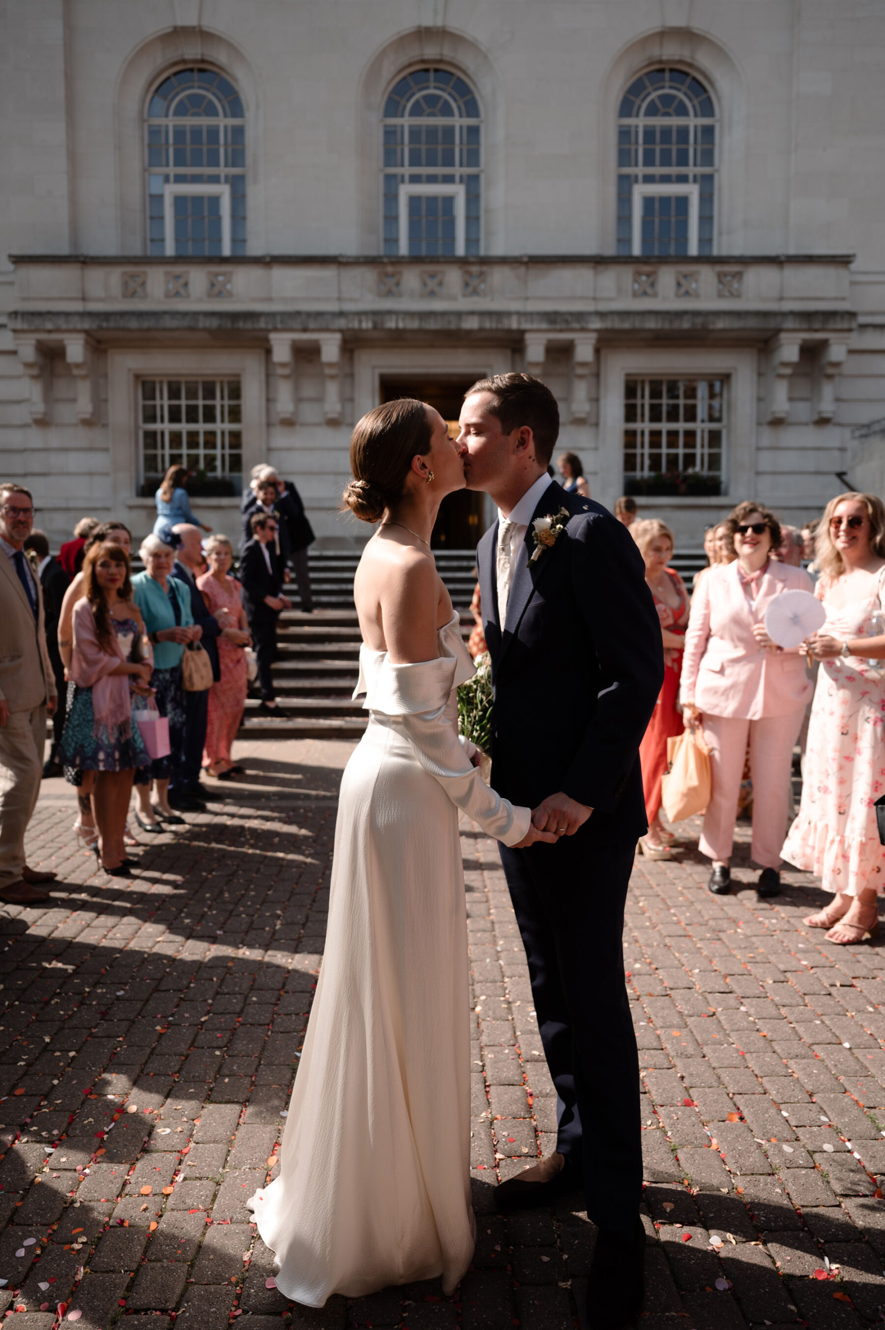 A Chic London Wedding: Soraya's Nikeen Asar Dress Captured by Taylor-Hughes Photography 17 Bride and groom kissing outside Hackney Town Hall after their wedding ceremony. The bride wears a Nikeen Asar wedding dress. Taylor-Hughes Photography.
