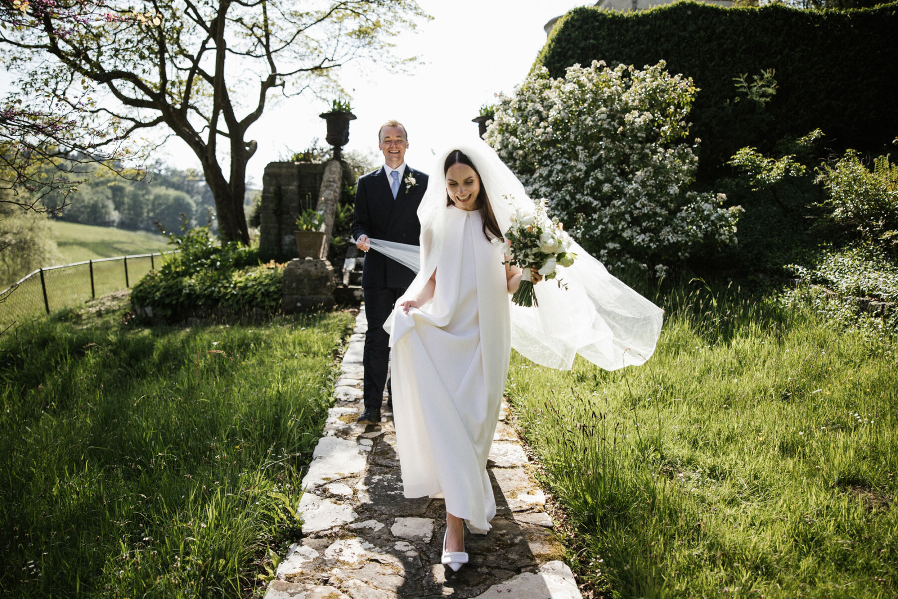 Bride wearing an Emilia Wickstead wedding dress, veil and shoes. Through The Woods We Ran Photography.