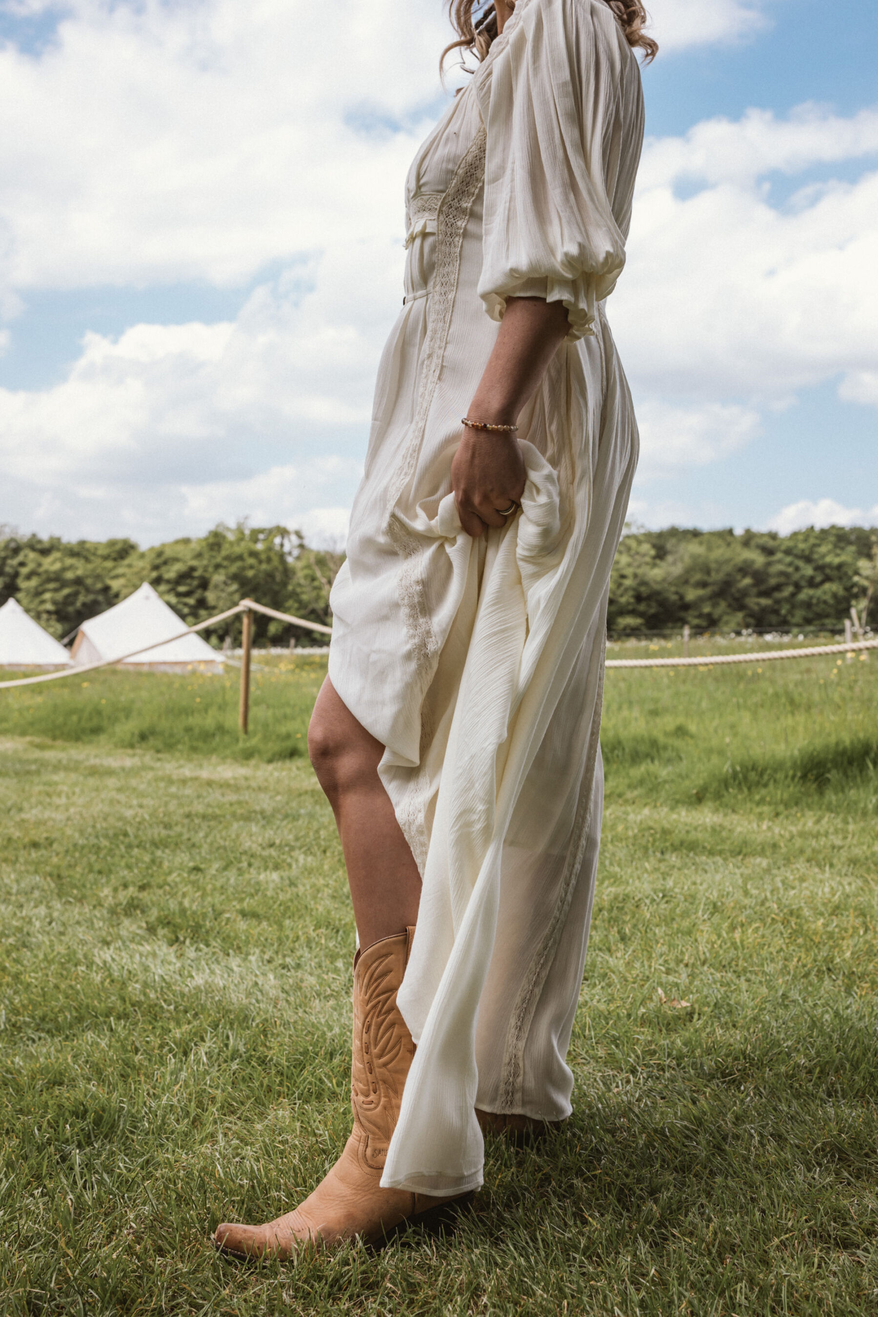 Wickerwood Farm, an Eco Friendly, Glamping Wedding Venue in East Sussex 3 Bride wearing cowboy boots and a Free People wedding dress.