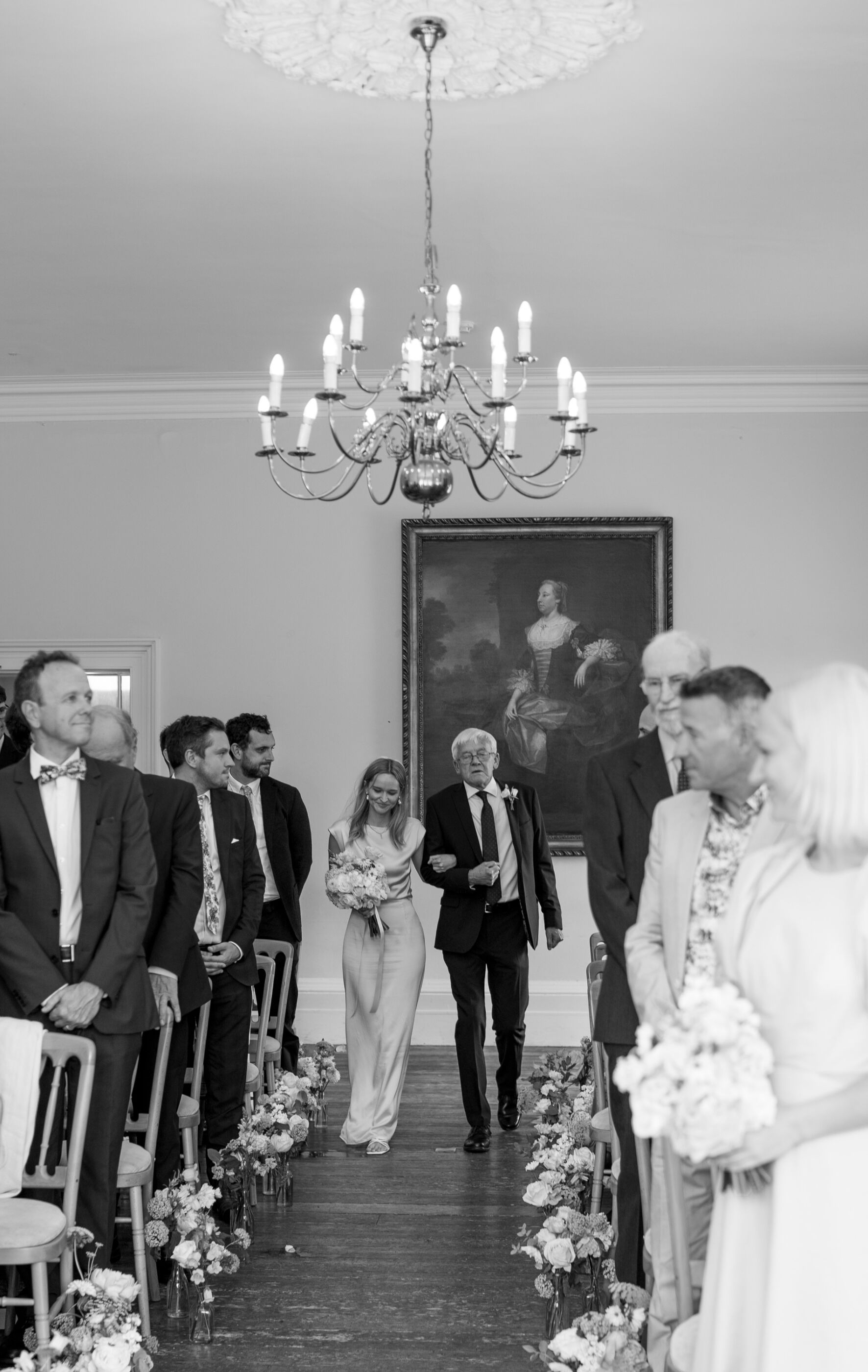 Relaxed, Romantic & Organic: Elena and Oliver's Cambridge Cottage Wedding at Kew Gardens 22 Bride walking down the aisle arm in arm with her father, inside Cambridge Cottage at Kew Gardens.