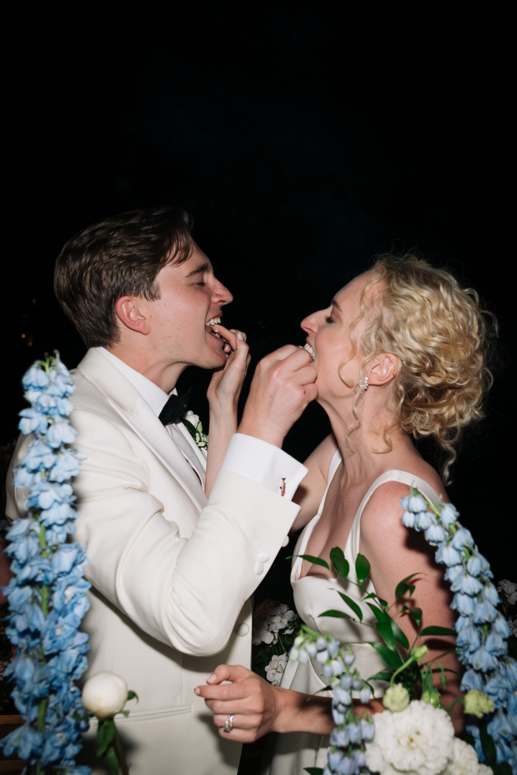 Georgia in Emilia Wickstead, For Her Classy & Elegant Black Tie Mountain Wedding in the Chamonix 38 Bride and groom feeding each other wedding caake
