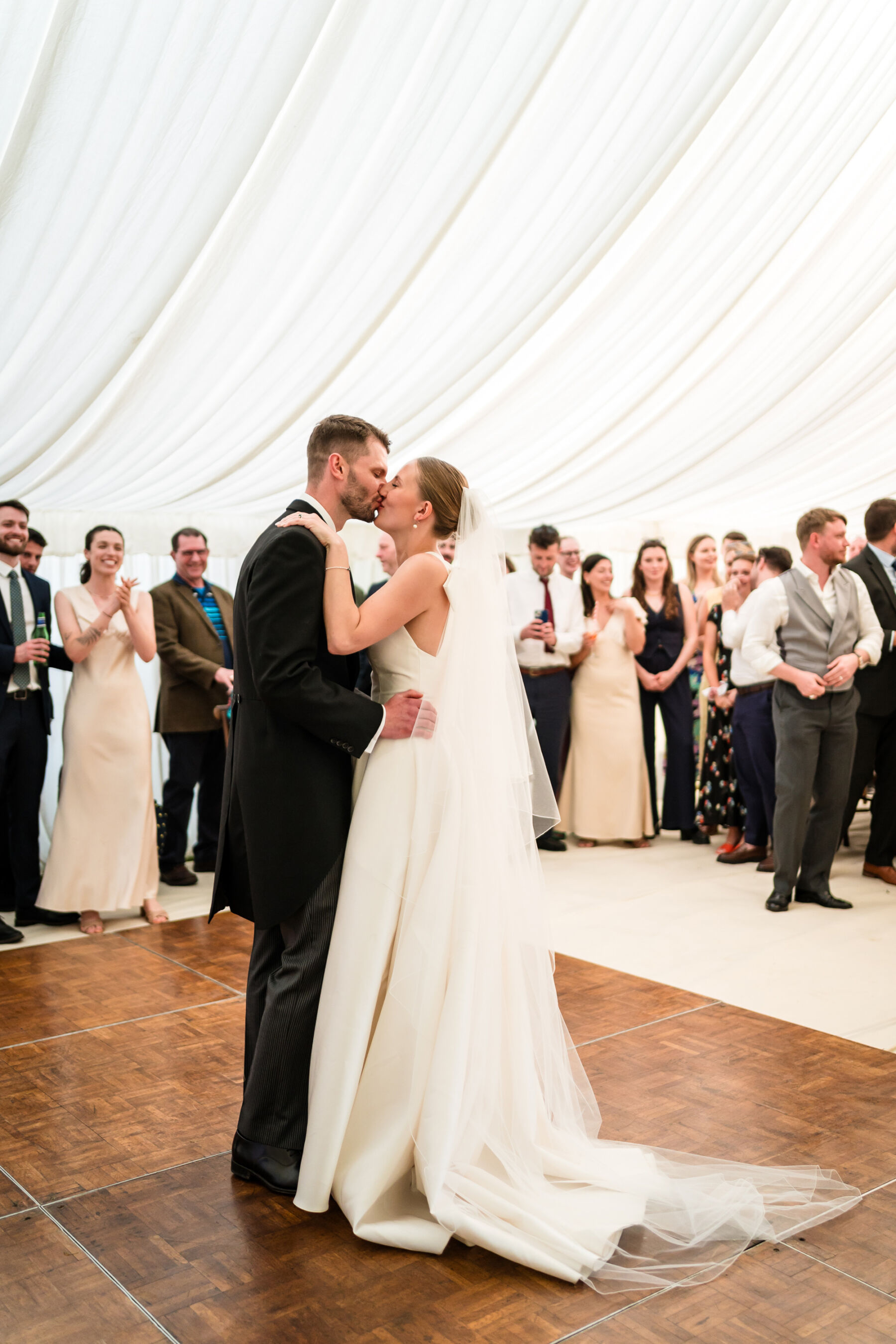 Alice Wore Oak by Halfpenny London For Her Charming Spring Marquee Wedding in Suffolk 37 Bride and groom dancing and kissing inside their wedding marquee.