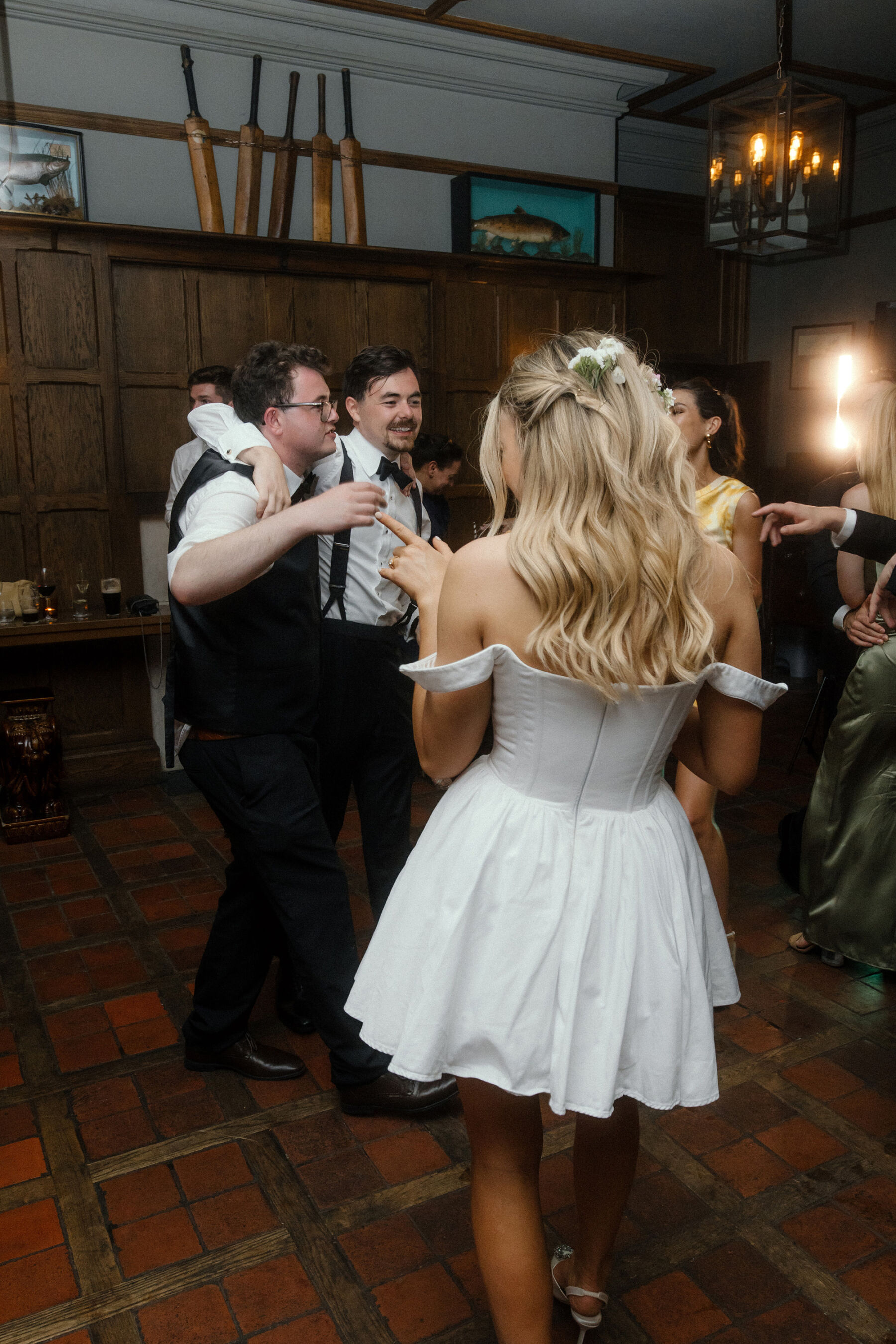 Romantic Ballynahinch Castle Wedding: Ciara in Danielle Frankel 37 Bride wearing a short dress by Annie's Ibiza as she dances with her husband and wedding guests.