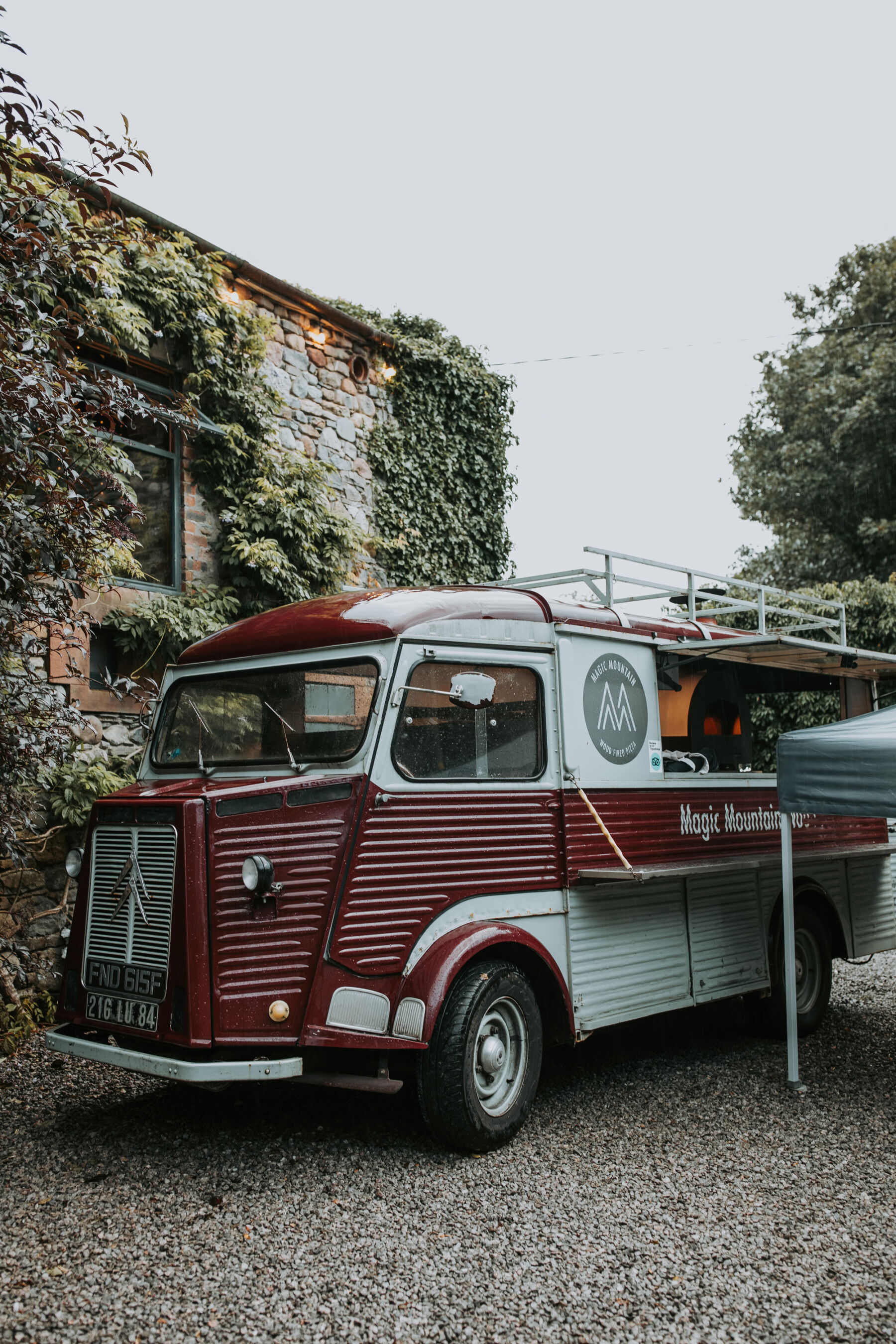 Sophie & Hal's Joyful, Colourful & Sustainable DIY Barn Wedding at Low Hall The Lakes 52 Magic Mountain Pizza Company street food truck, outside Low Hall The Lakes wedding venue in The Lake District.