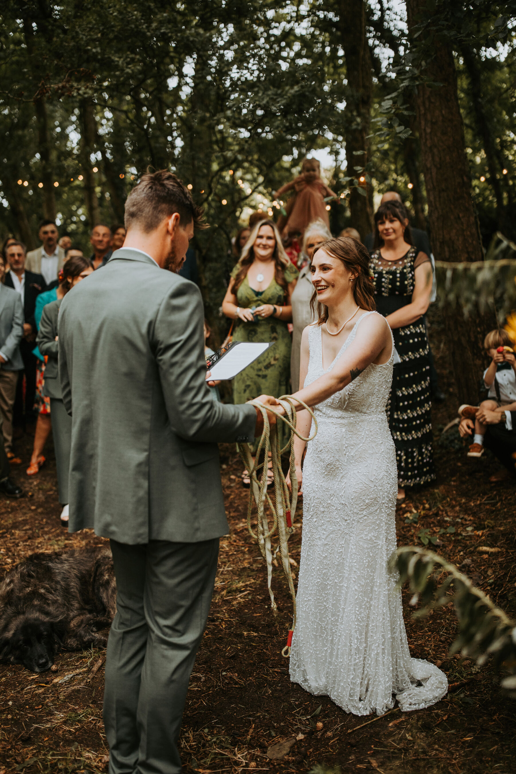 Sophie & Hal's Joyful, Colourful & Sustainable DIY Barn Wedding at Low Hall The Lakes 34 Hand fasting wedding ceremony in the woods at Low Hall The Lakes, The Lake District.