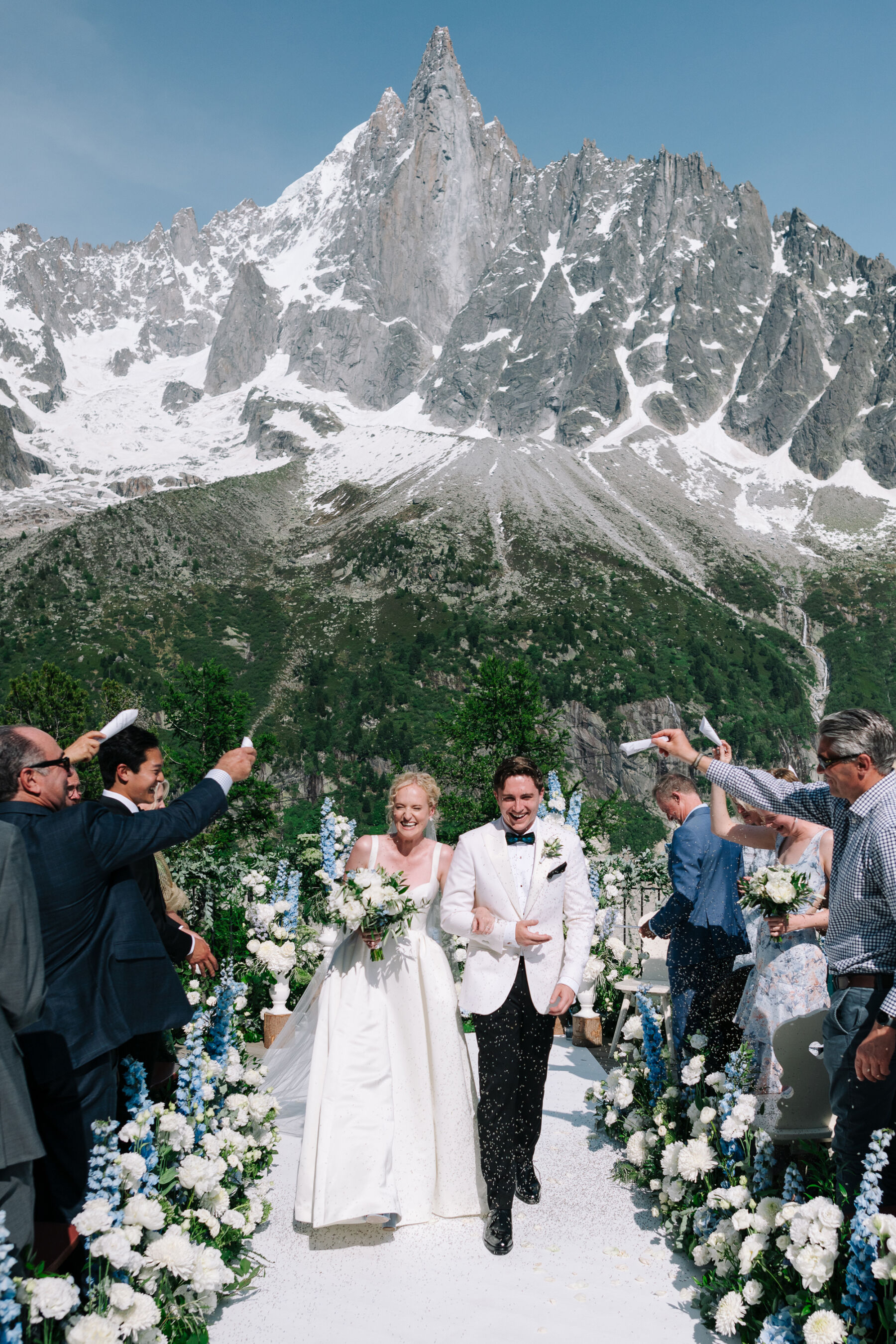 Georgia in Emilia Wickstead, For Her Classy & Elegant Black Tie Mountain Wedding in the Chamonix 20 Outdoor wedding at Mont Blanc in Chamonix France, the mountain rises in the background of the wedding reception.