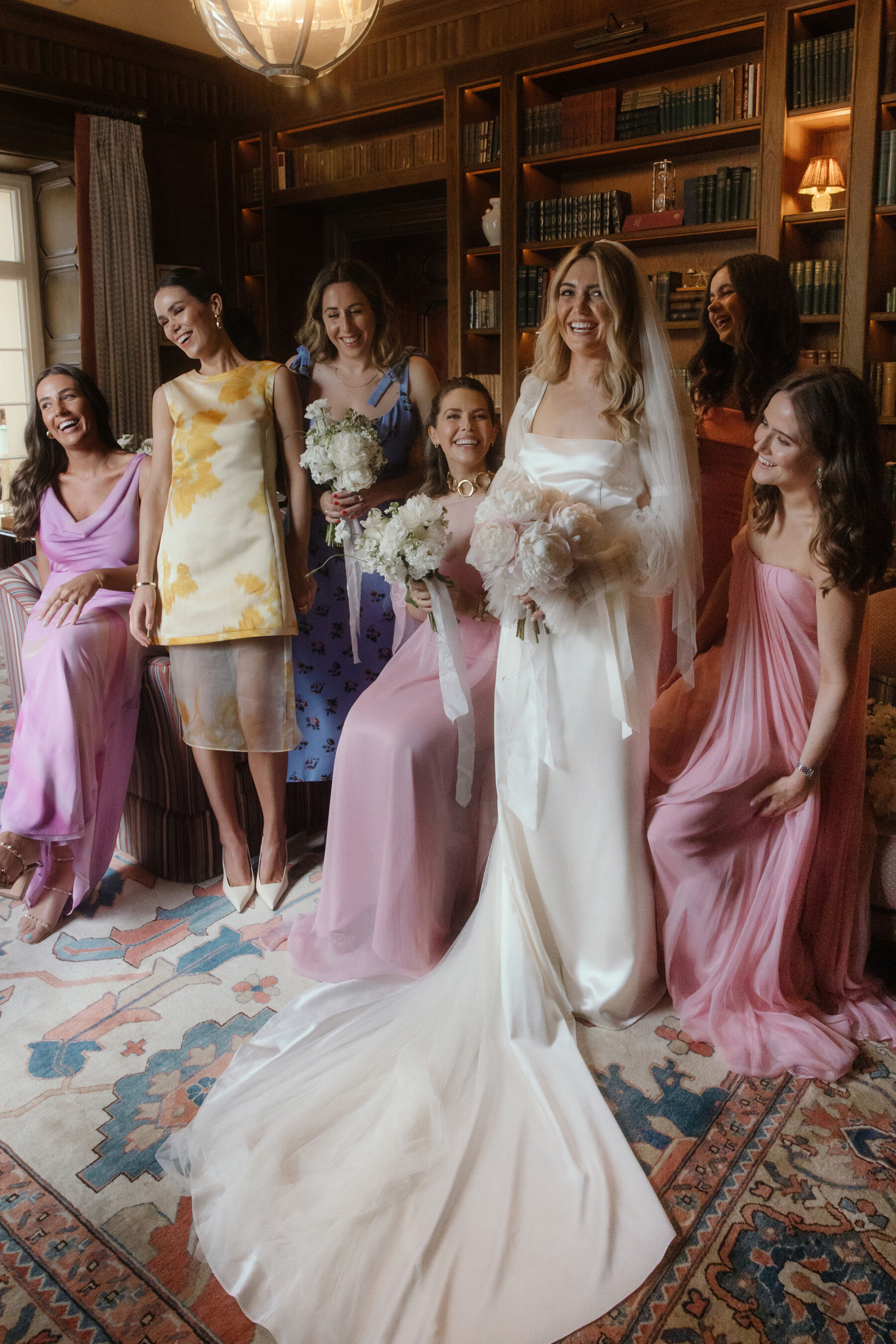 Romantic Ballynahinch Castle Wedding: Ciara in Danielle Frankel 14 Bridesmaids in pink and a bride wearing a Danielle Frankel wedding dress and single tier veil. She has long, loose wavy hair and all the ladies carry all-white bouquets.