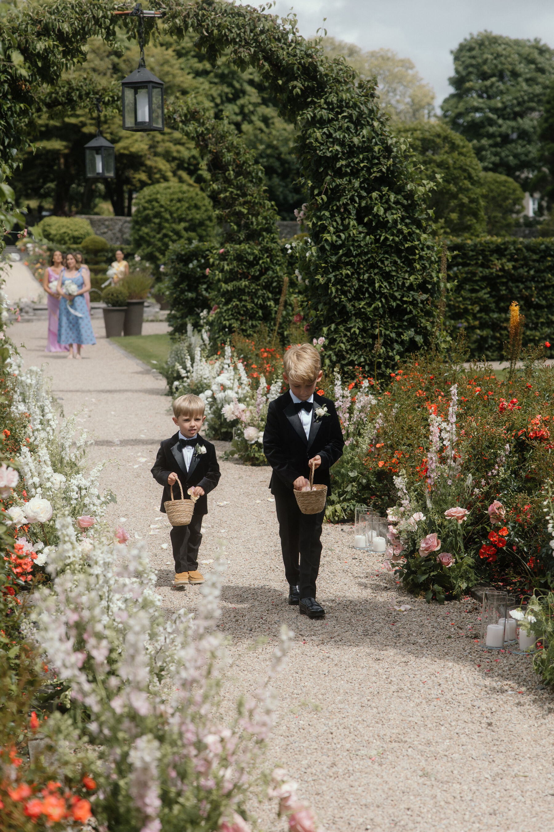 Romantic Ballynahinch Castle Wedding: Ciara in Danielle Frankel 18 Little page boys walking down the wedding aisle carrying baskets of petals to scatter.