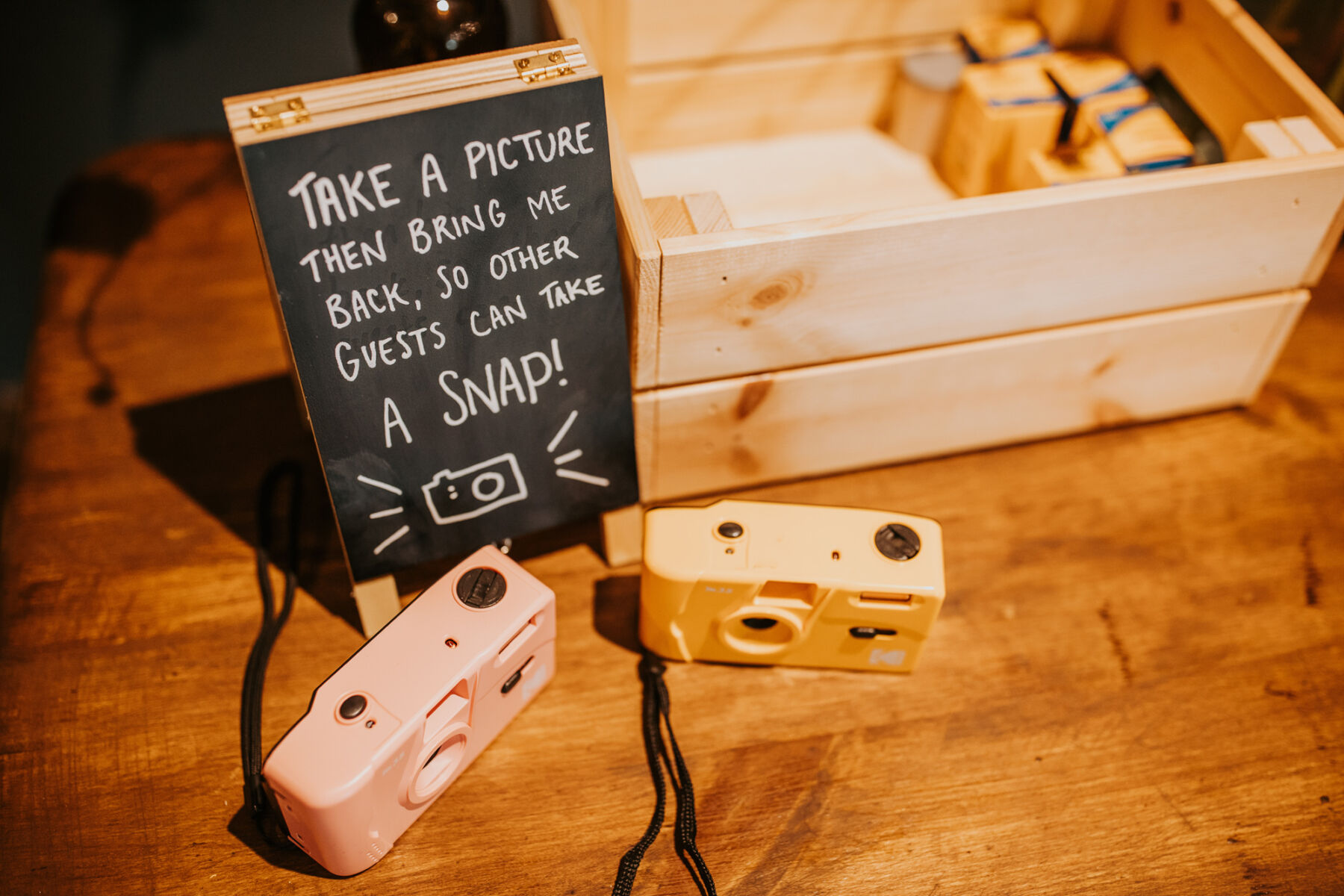 Sophie & Hal's Joyful, Colourful & Sustainable DIY Barn Wedding at Low Hall The Lakes 46 Take a picture then bring me back, so other guests can take a snap! Mini blackboard sign next to some disposable cameras at a wedding.