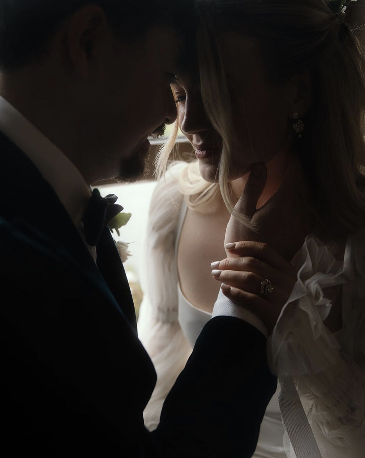 Romantic Ballynahinch Castle Wedding: Ciara in Danielle Frankel 27 Romantic wedding image of bride and groom tenderly holding one another's faces. She wears Danielle Frankel.