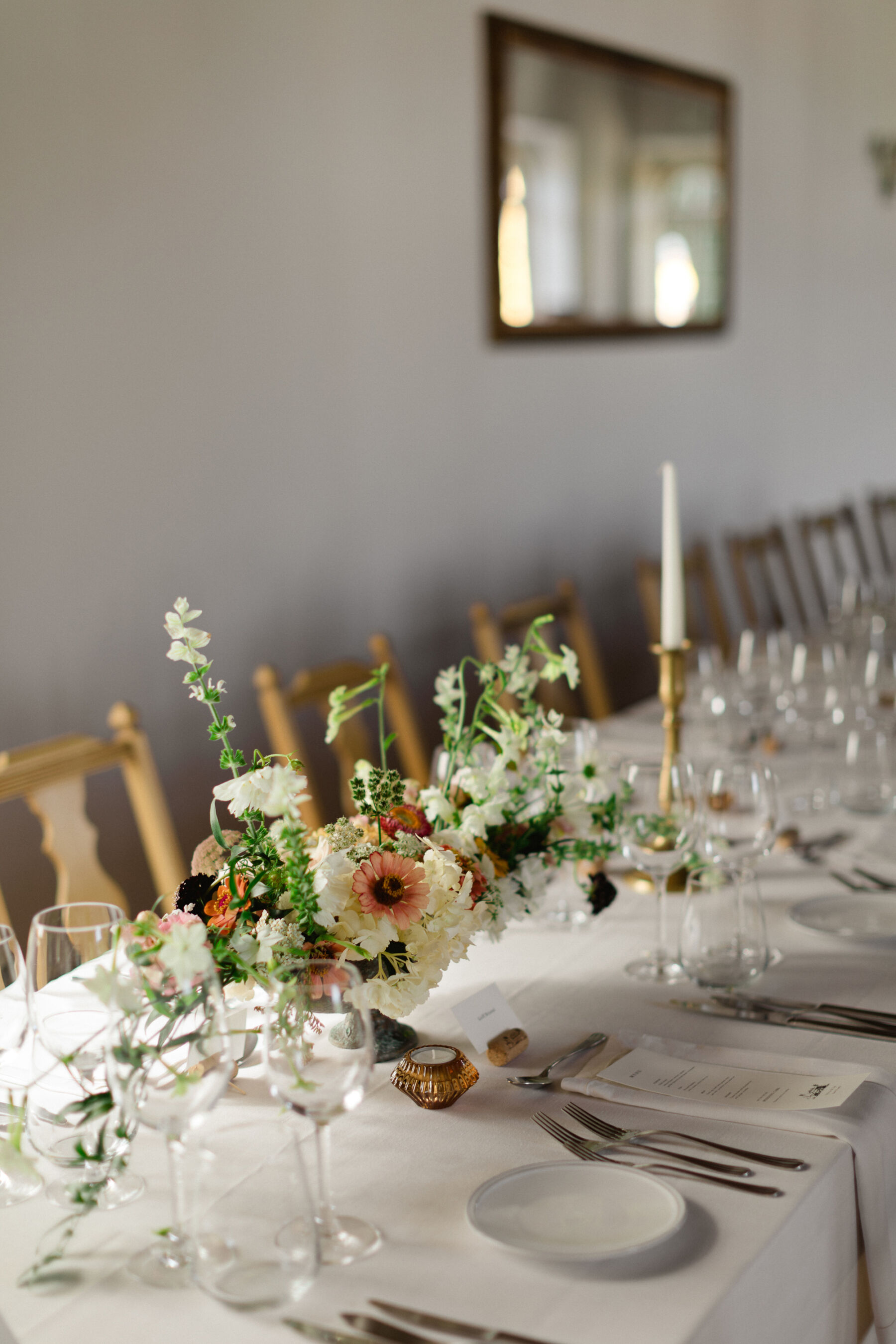Olivia & Tim's Classy & Elegant Vineyard Wedding in Portugal 40 Elegant wedding flowers in bowls on long tables with white table cloths, gold candlestick holders and white tableware.