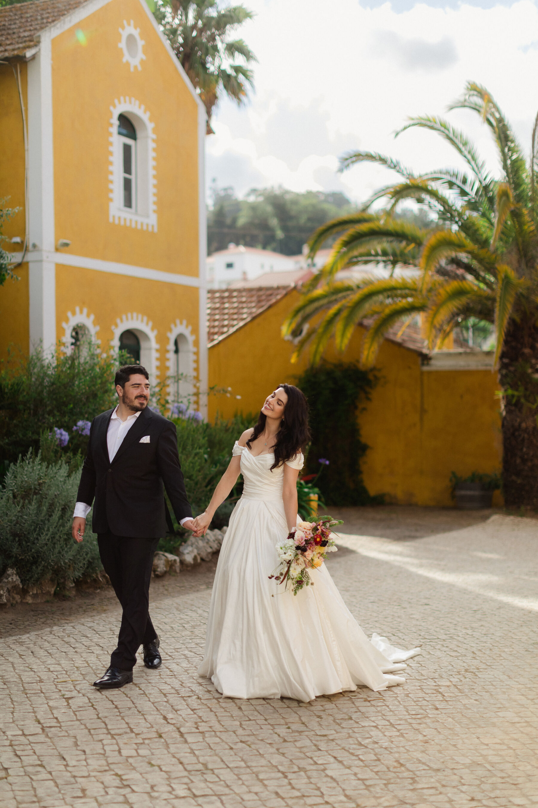 Olivia & Tim's Classy & Elegant Vineyard Wedding in Portugal 35 Bride and groom wondering the streets at their wedding in Portugal.
