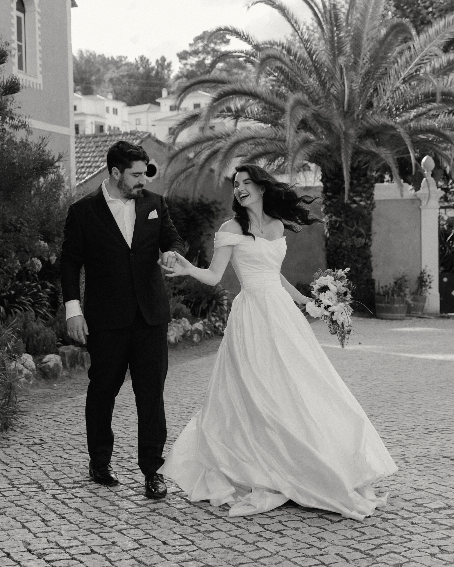Olivia & Tim's Classy & Elegant Vineyard Wedding in Portugal 6 Bride and groom holding hands and dancing in the streets of Portugal.