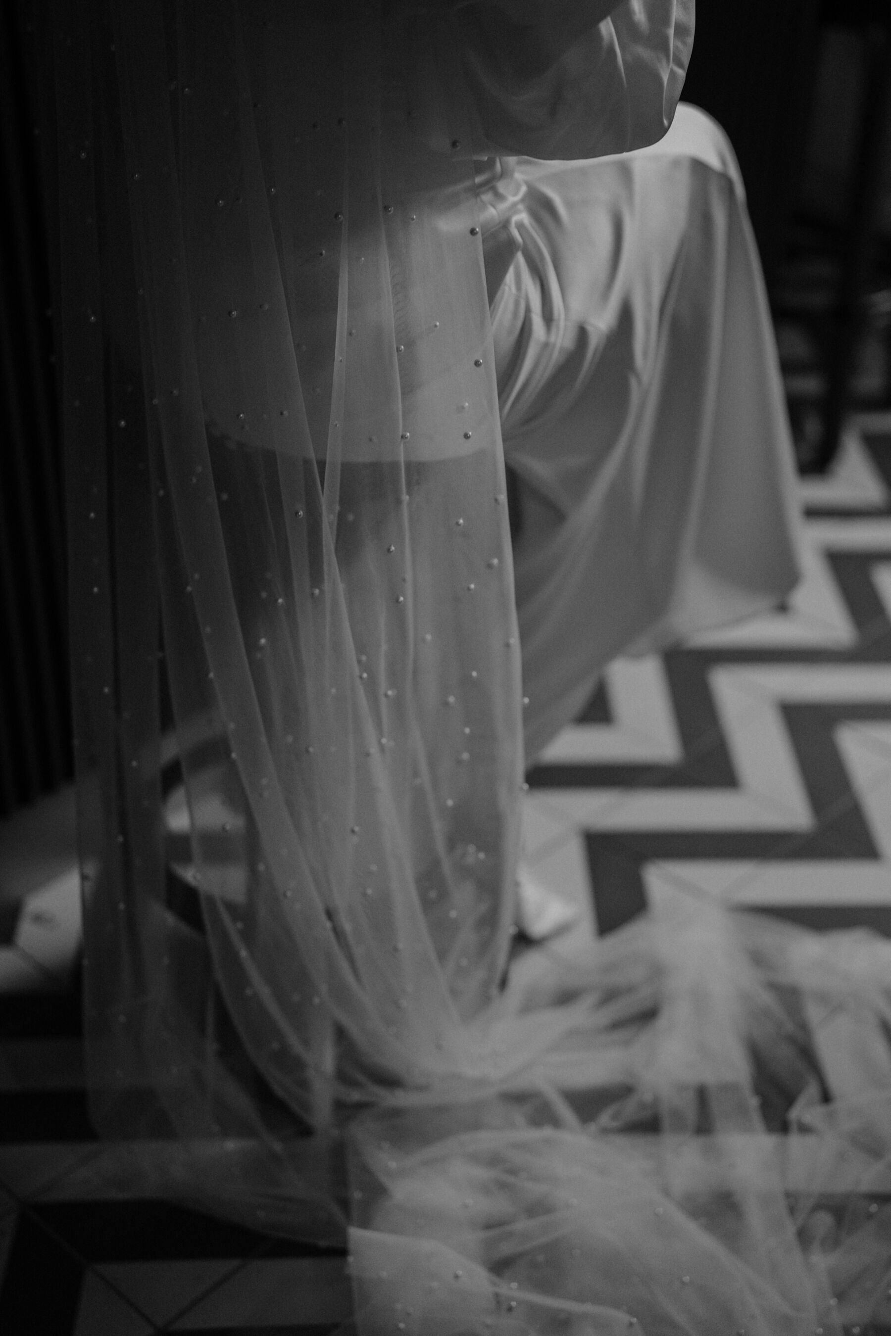 Draped wedding veil covered in pearls.