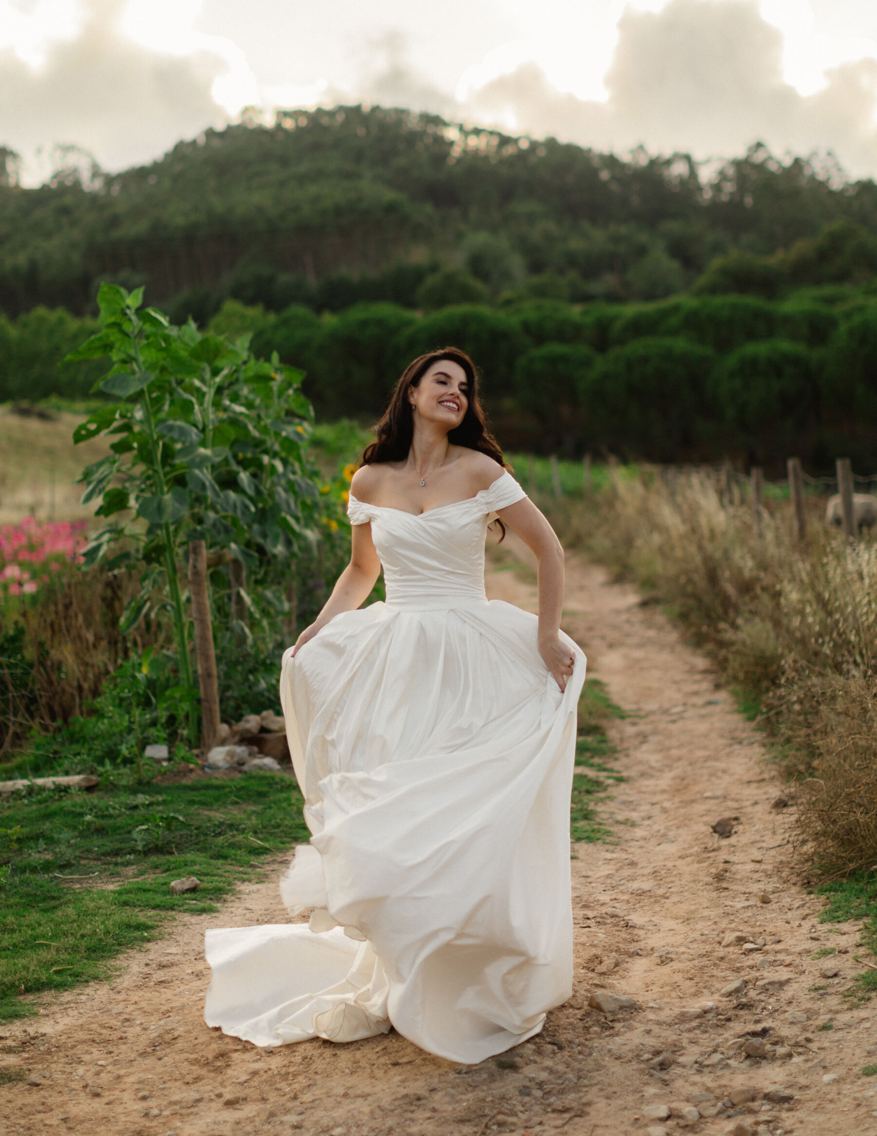 Olivia & Tim's Classy & Elegant Vineyard Wedding in Portugal 33 Beautiful bride walking through a vineyard in Portugal.