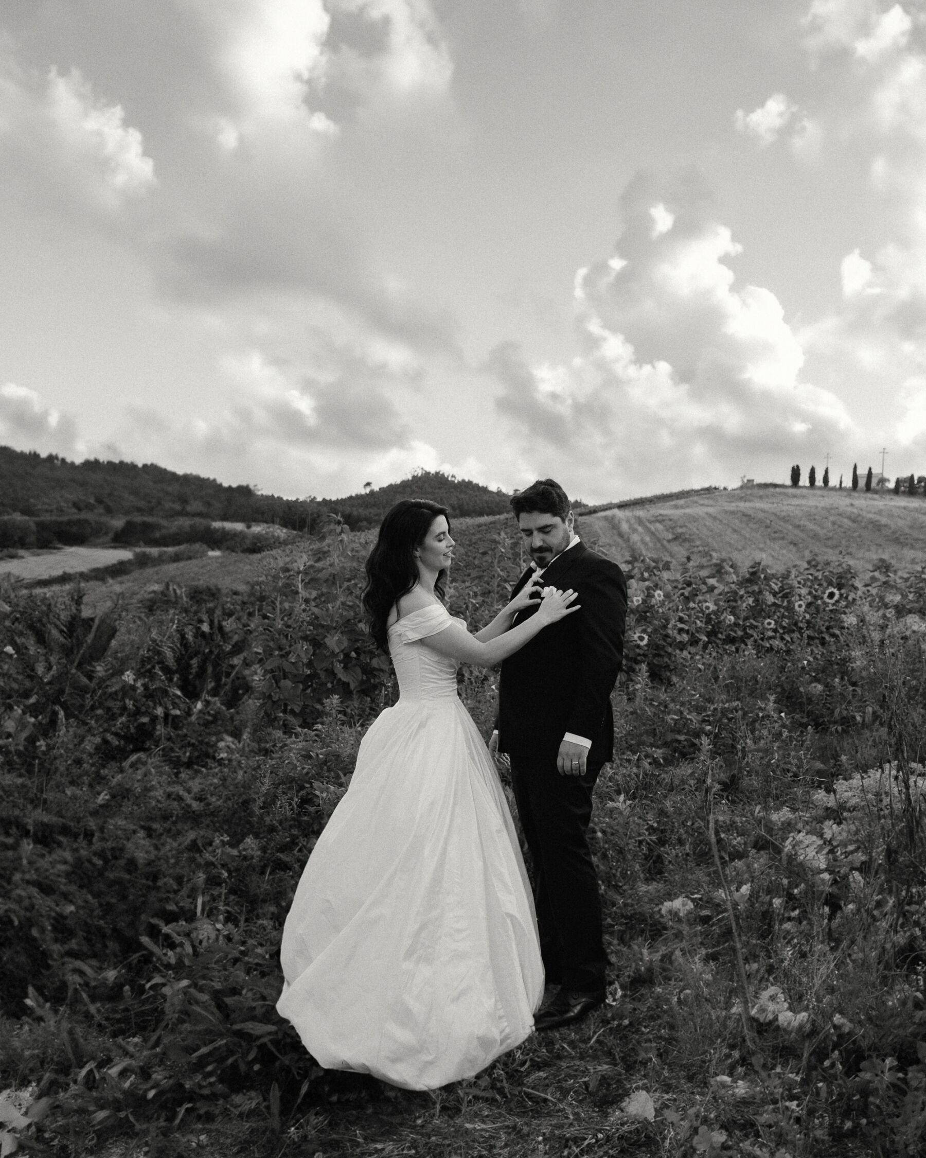 Olivia & Tim's Classy & Elegant Vineyard Wedding in Portugal 32 Classy black and white photograph of a bride and groom walking through a vineyard in Portugal.
