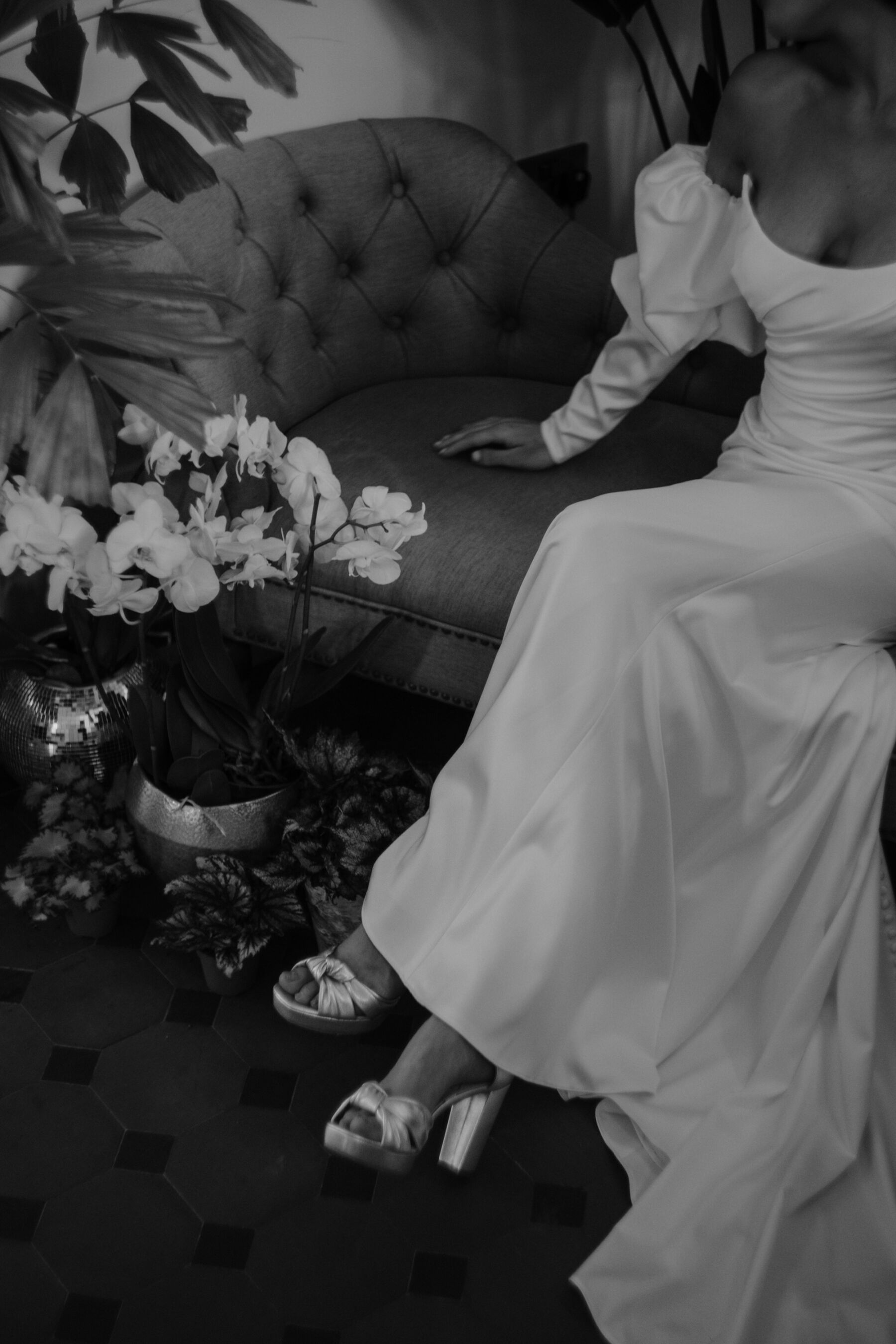 Bride wearing gold platform bridal shoes and a Watters dress with puff sleeves.