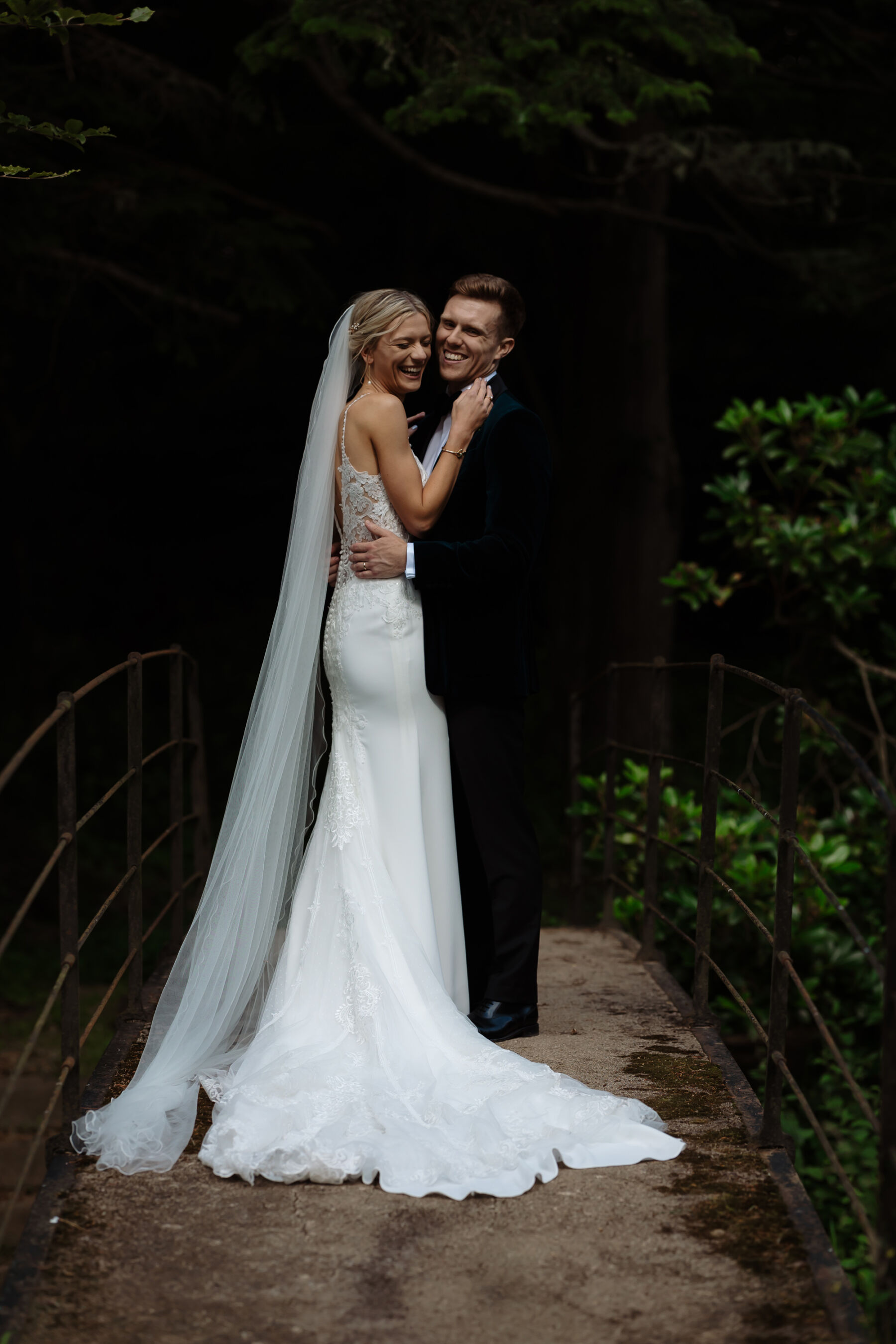 Emily in Rosa Clara for her Romantic & Elegant July Wedding at Cluny Castle 37 Bride wearing a Rosa Clara wedding dress and groom in a dark blue green tuxedo.