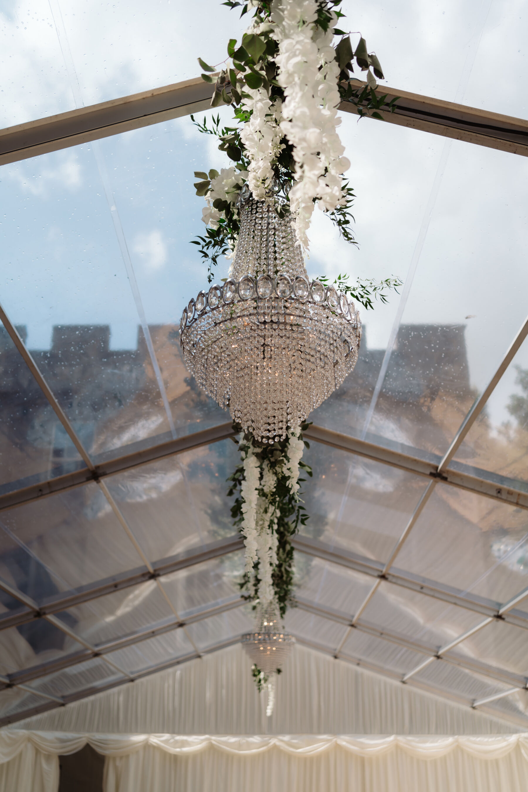 Emily in Rosa Clara for her Romantic & Elegant July Wedding at Cluny Castle 32 Crystal chandelier suspended from a marquee ceiling at Cluny Castle.