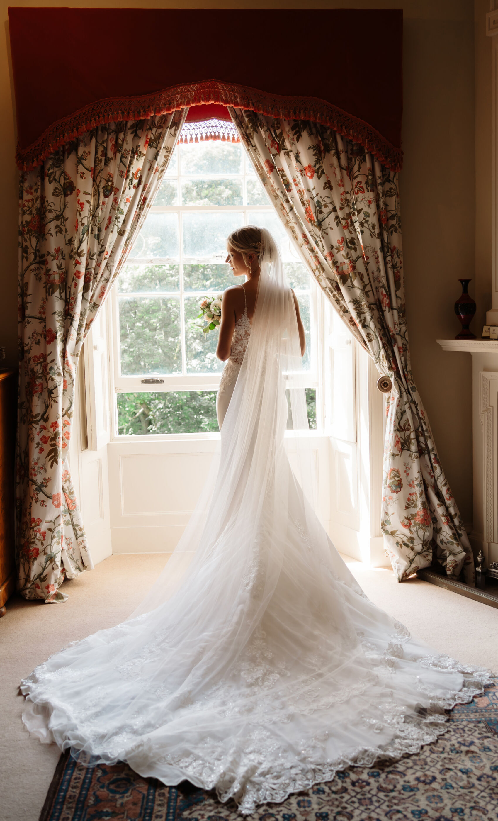 Emily in Rosa Clara for her Romantic & Elegant July Wedding at Cluny Castle 20 Bride standing by the window inside Cluny Castle in a Rosa Clara wedding dress.