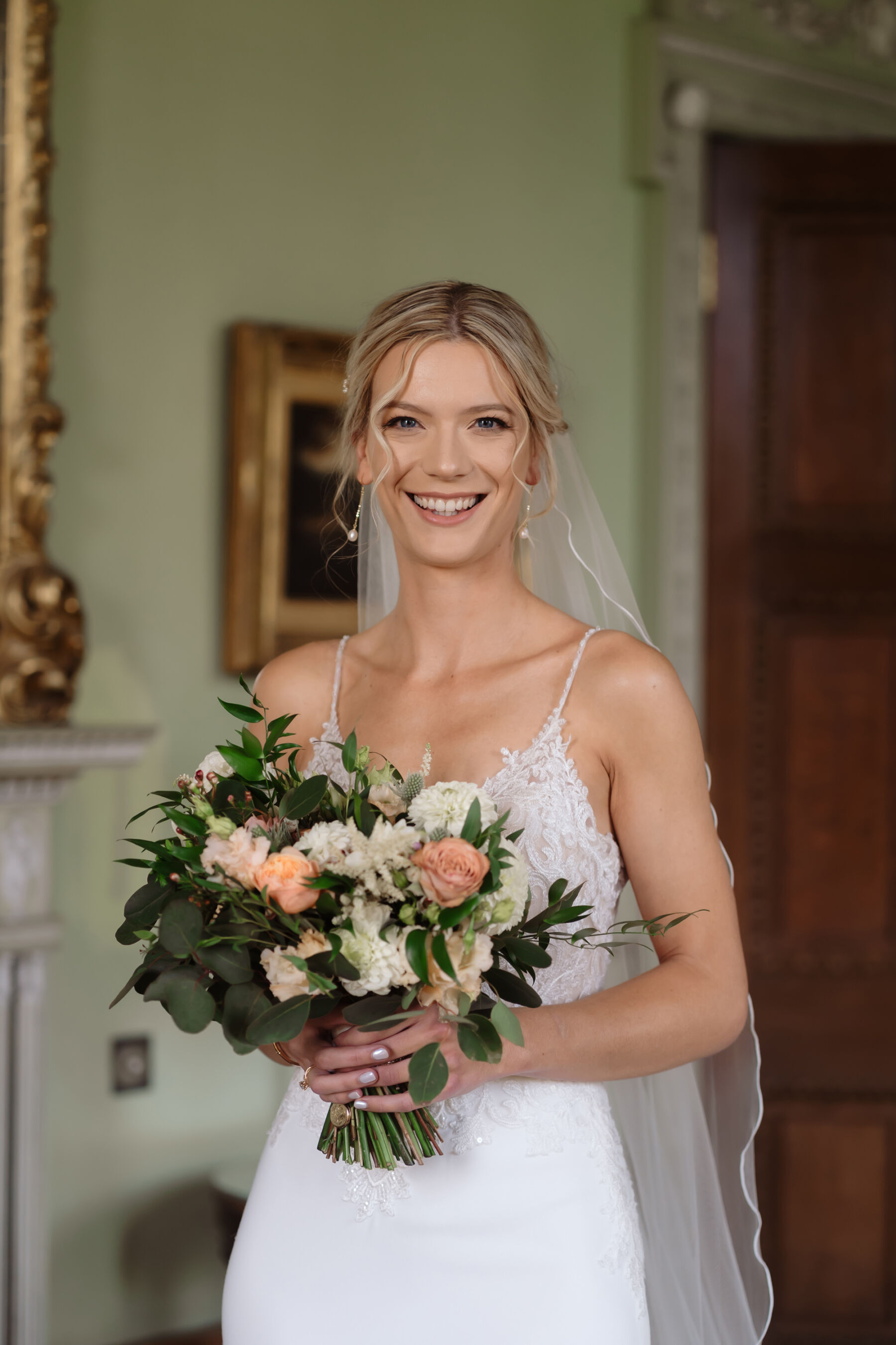 Emily in Rosa Clara for her Romantic & Elegant July Wedding at Cluny Castle 19 Happy modern bride carrying an elegant peach bouquet.