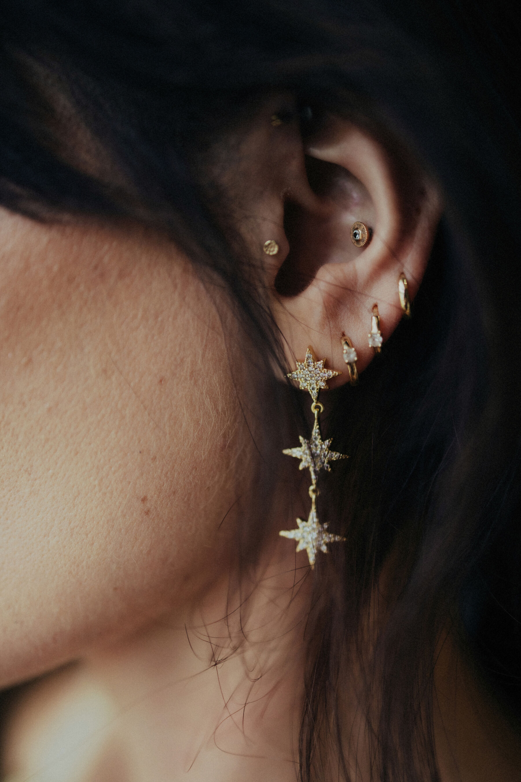 Close up photograph of a bride wearing starry, celestial inspired earrings.
