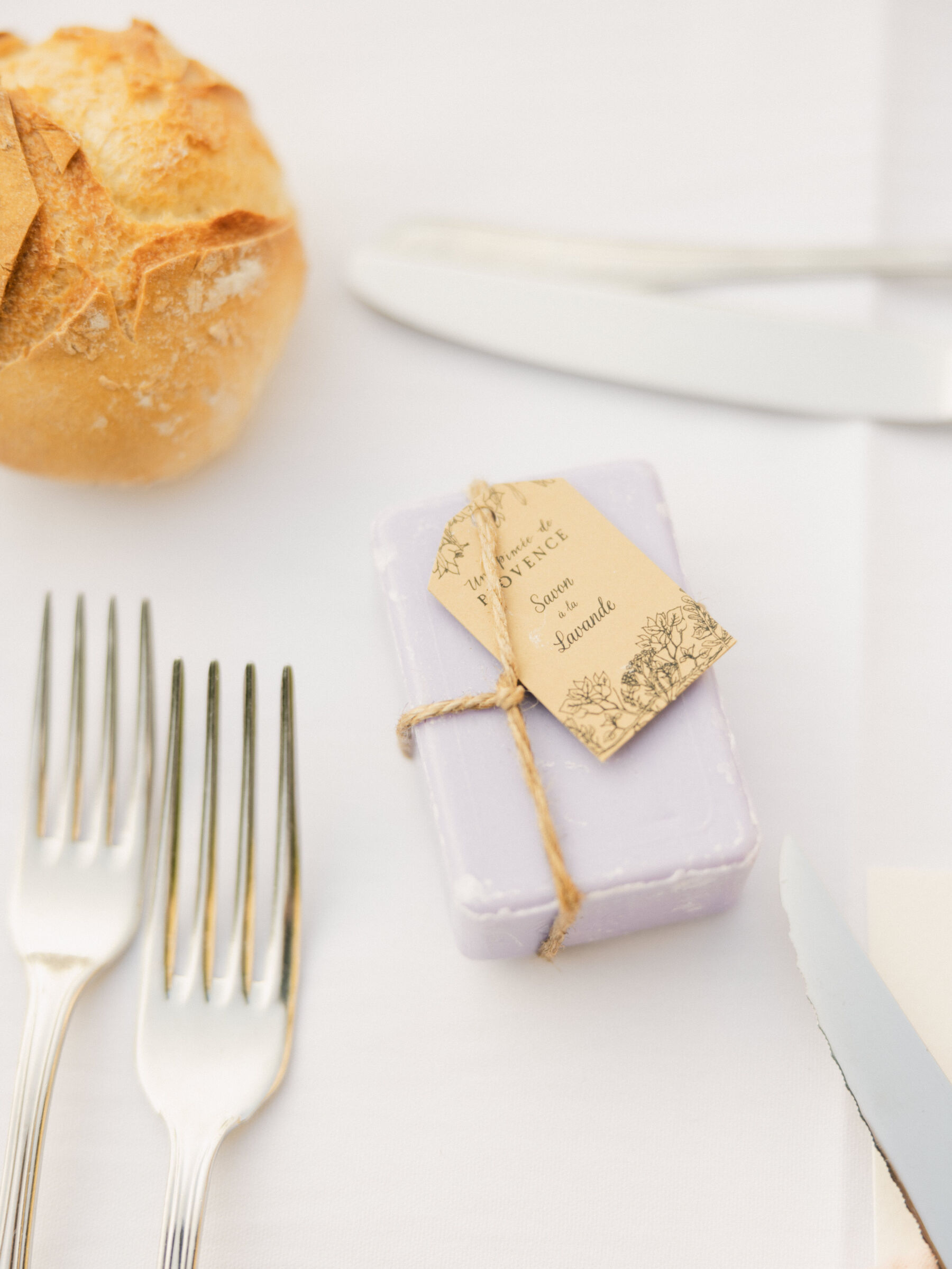 French Riviera Chic Wedding at Château Robernier, Provence, with Lawyer Chanel in Sassi Holford 34 Lavender soap from Provence wrapped in lavendar paper and tied with twine. Wedding favour. Wedding at Chateau Robernier in Cotignac, Provence, France. Sébastien Boudot Photography.