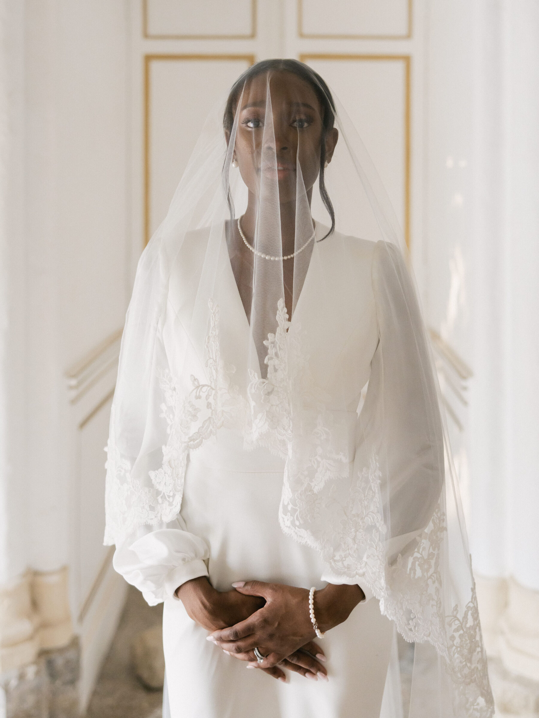 French Riviera Chic Wedding at Château Robernier, Provence, with Lawyer Chanel in Sassi Holford 21 Black bride wearing a Sassi Holford dress and beautiful veil with a lace trim over her face. Wedding at Chateau Robernier in Cotignac, Provence, France. Sébastien Boudot Photography.