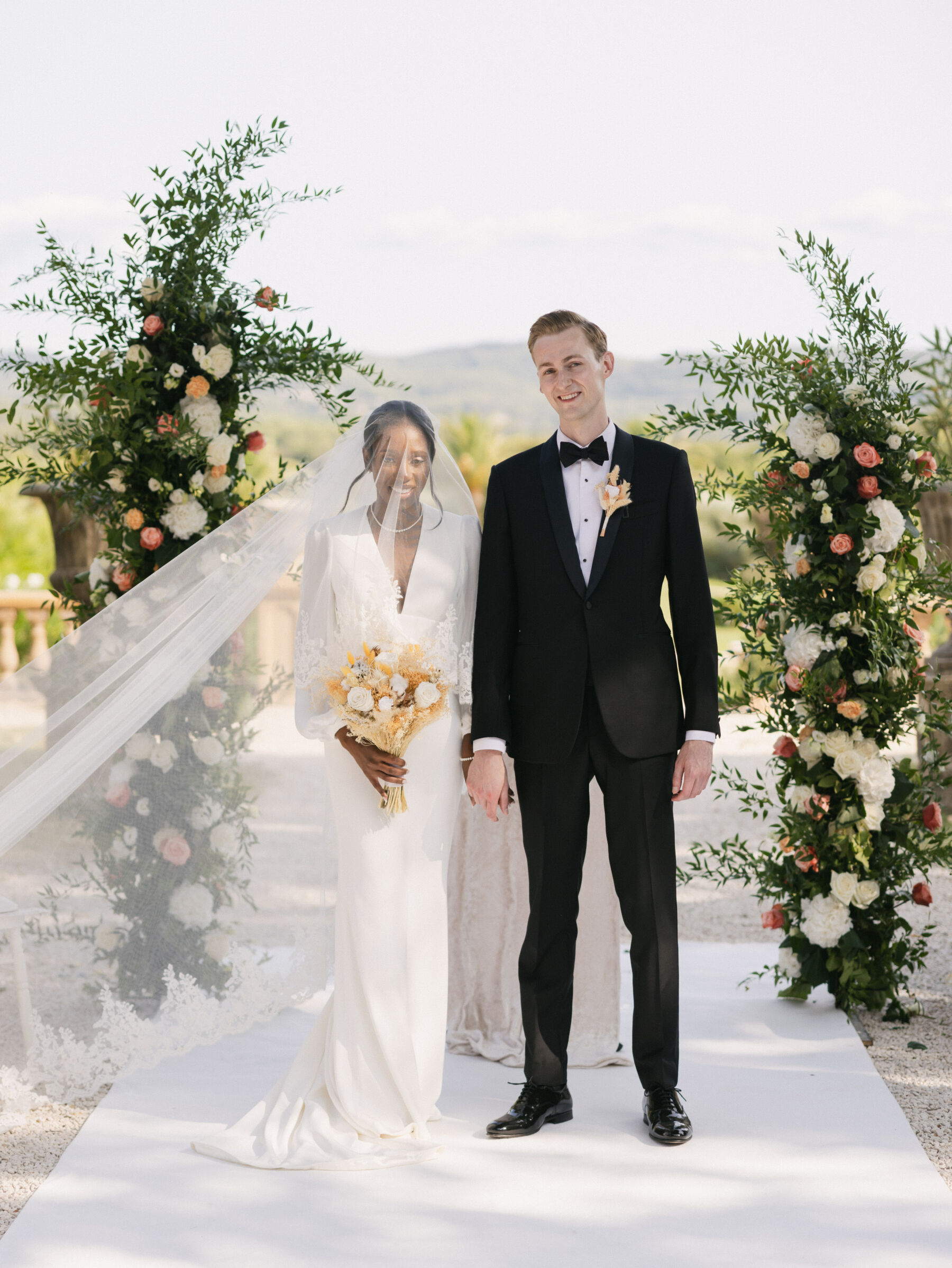 French Riviera Chic Wedding at Château Robernier, Provence, with Lawyer Chanel in Sassi Holford 23 Black bride wearing Sassi Holford being accompanied by the father of the bride to here ceremony at Chateau Robernier in Cotignac, Provence, France. Sébastien Boudot Photography.