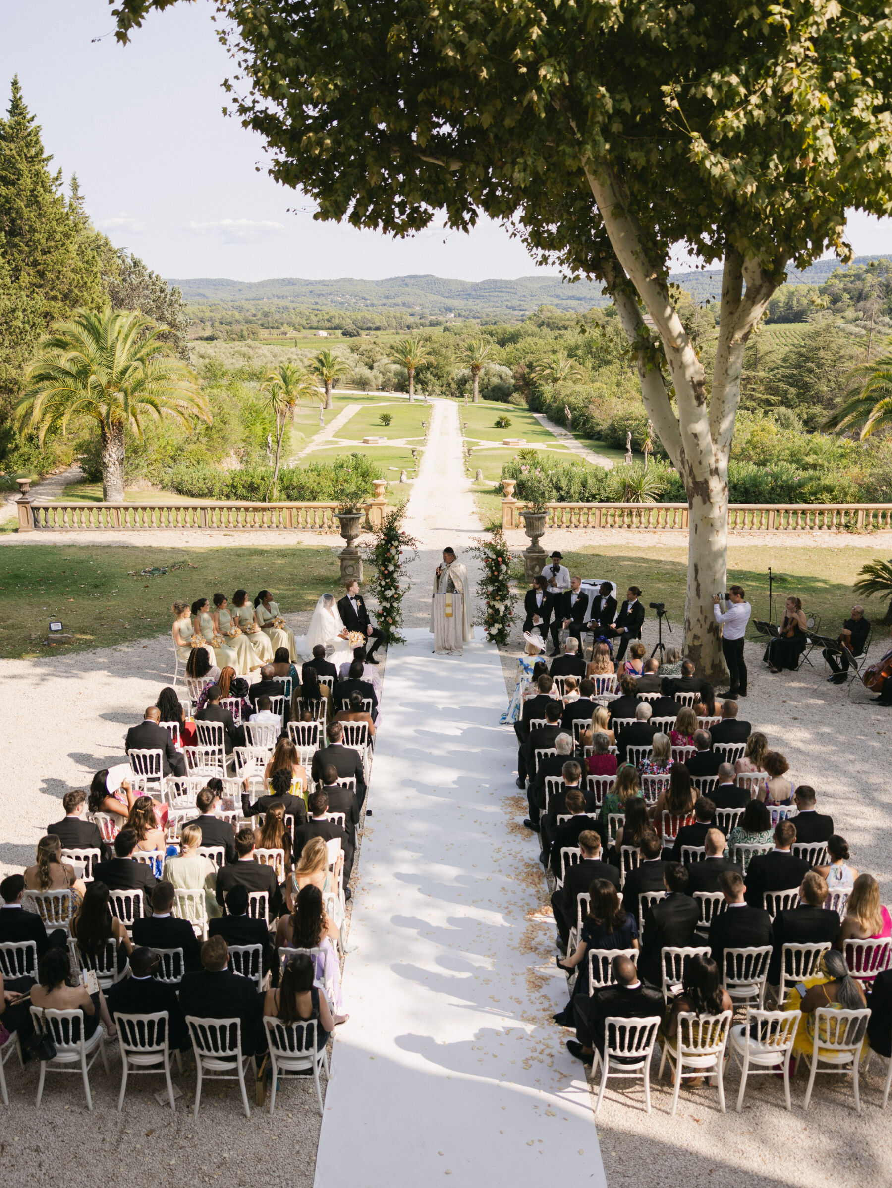 French Riviera Chic Wedding at Château Robernier, Provence, with Lawyer Chanel in Sassi Holford 25 Rows of seats for an outdoor wedding with a view at Chateau Robernier in Cotignac, Provence, France. Sébastien Boudot Photography.