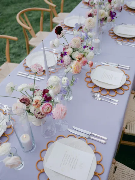 Lilac woven tablecloths used for an outside wedding tablescape setup