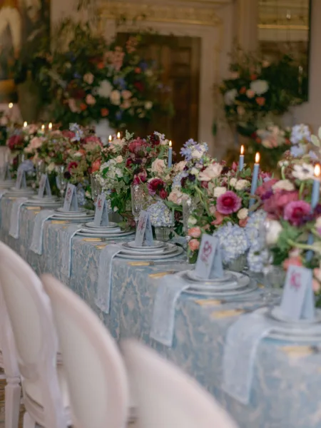 A blue & white pattern linen tablecloth used in a blue & pink wedding table setup