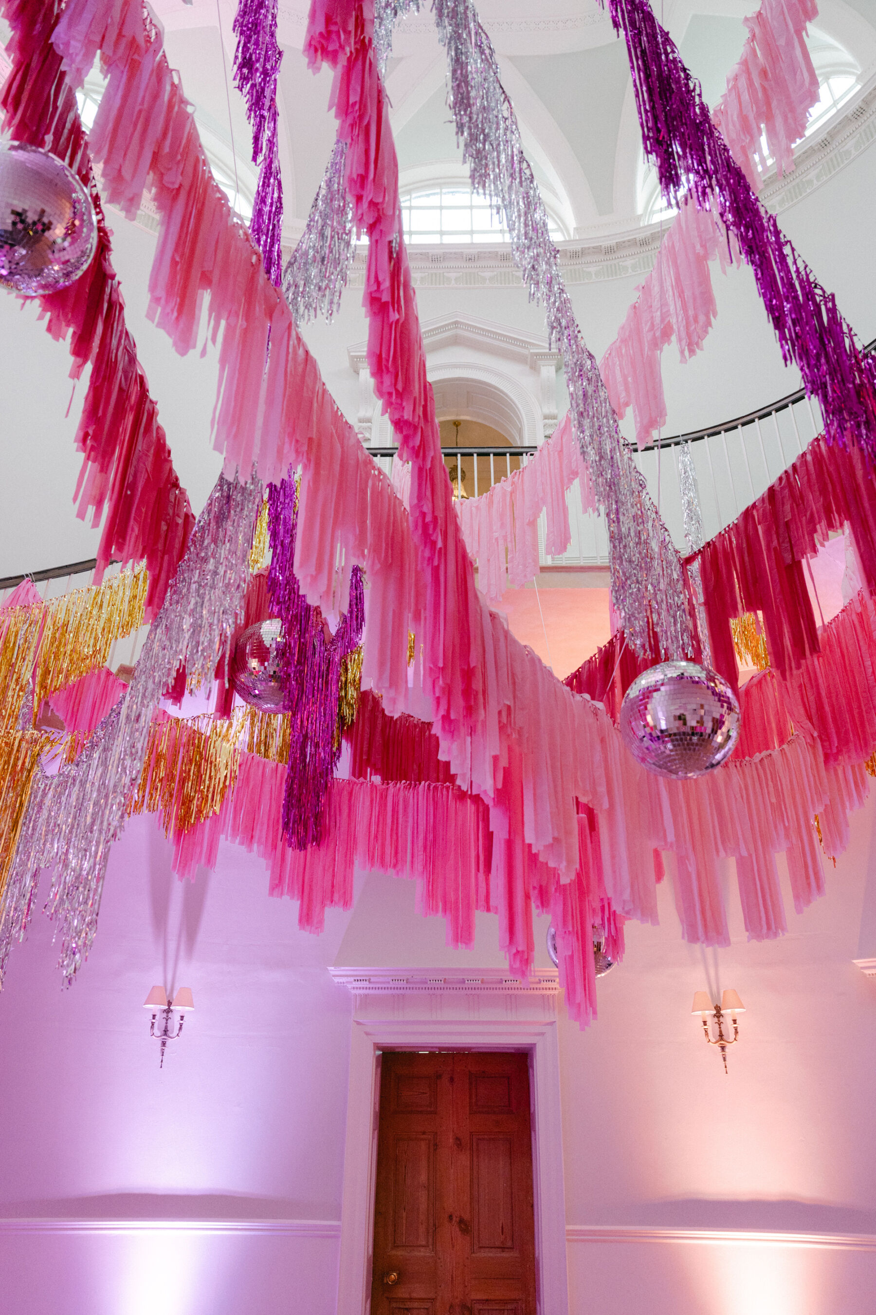 Pink tassels and disco balls draped form the ceiling at Middleton Lodge wedding venue.