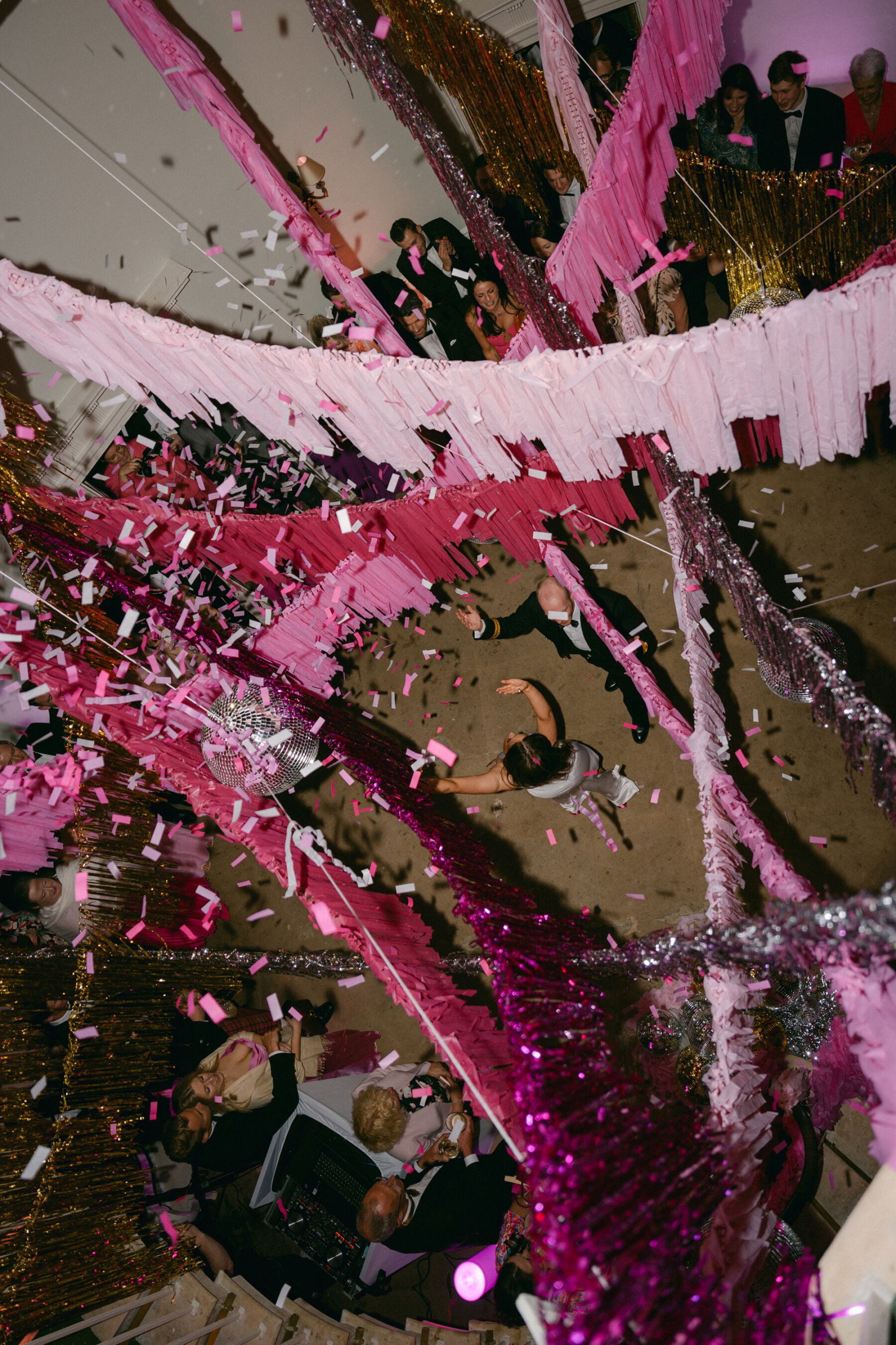 Birds eye view of a wedding dance floor at Middleton Lodge with pink paper tassels draped across the ceiling. 