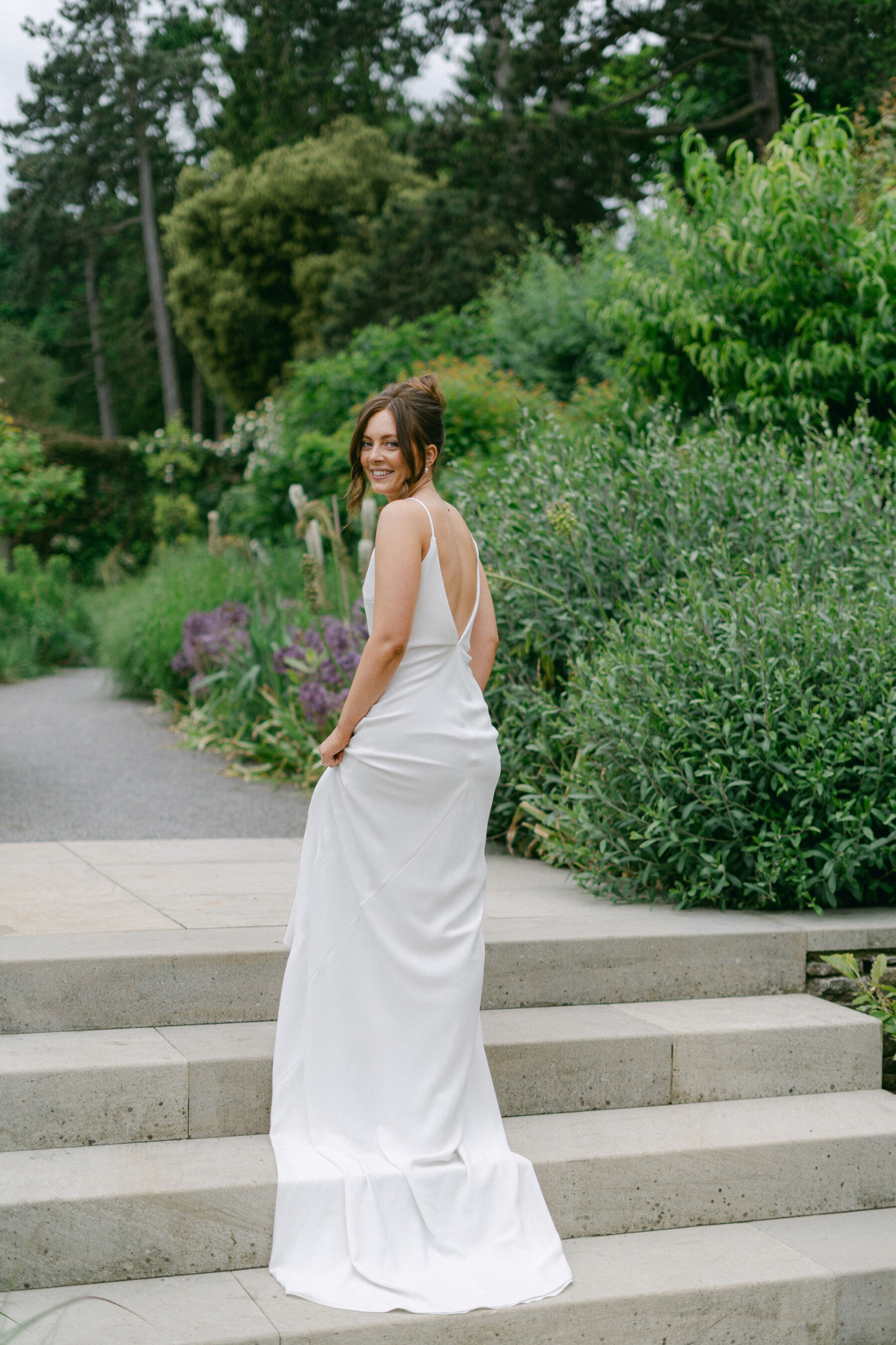 Bride in minimalist backless wedding dress by Love Story London. Middleton Lodge Estate wedding.