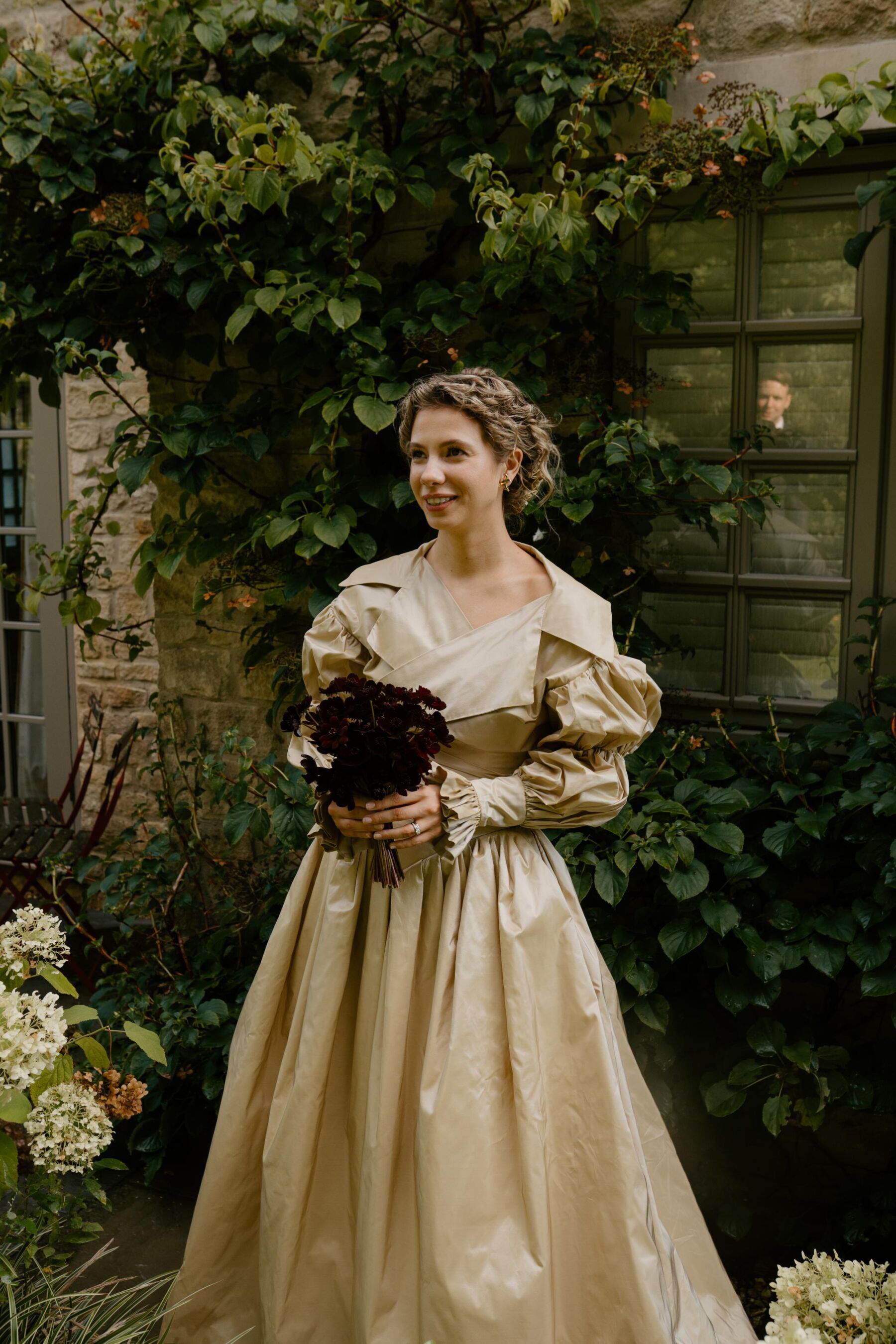 Bride wearing a gold wedding dress by Nortier.