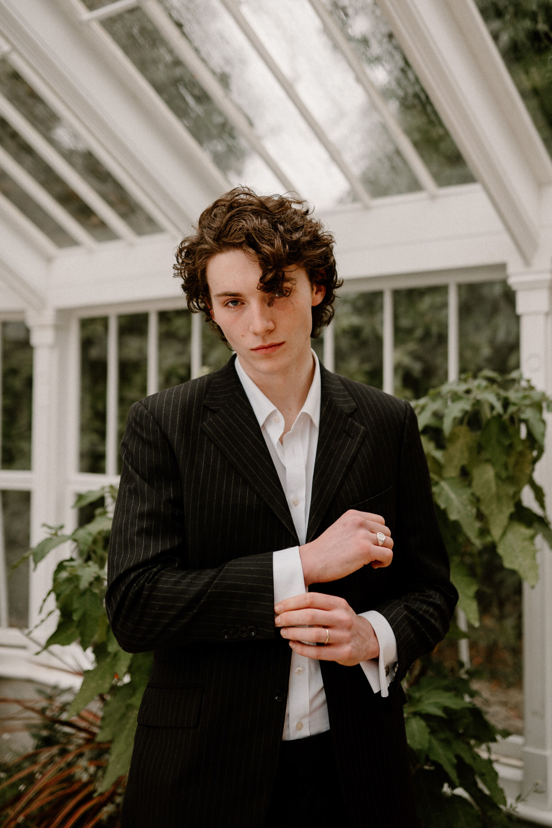 Young modern groom with unbuttoned shirt and no tie.