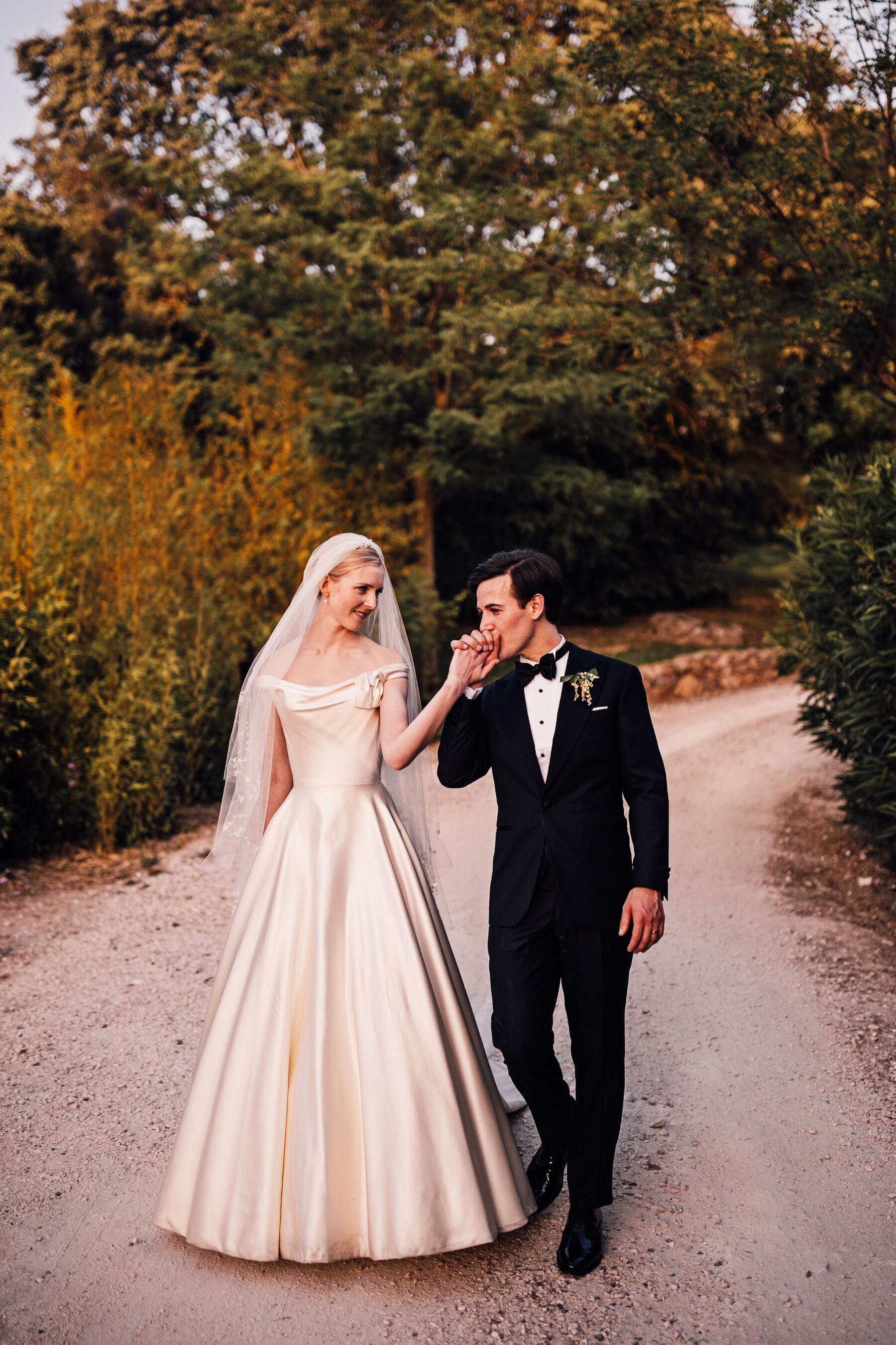 Alexandra Wore Phillipa Lepley For Her Romantic Destination Wedding in Spain 31 Bride and groom walking outdoors during their Spanish wedding. She wears Phillipa Lepley - the groom is in black tie tuxedo.