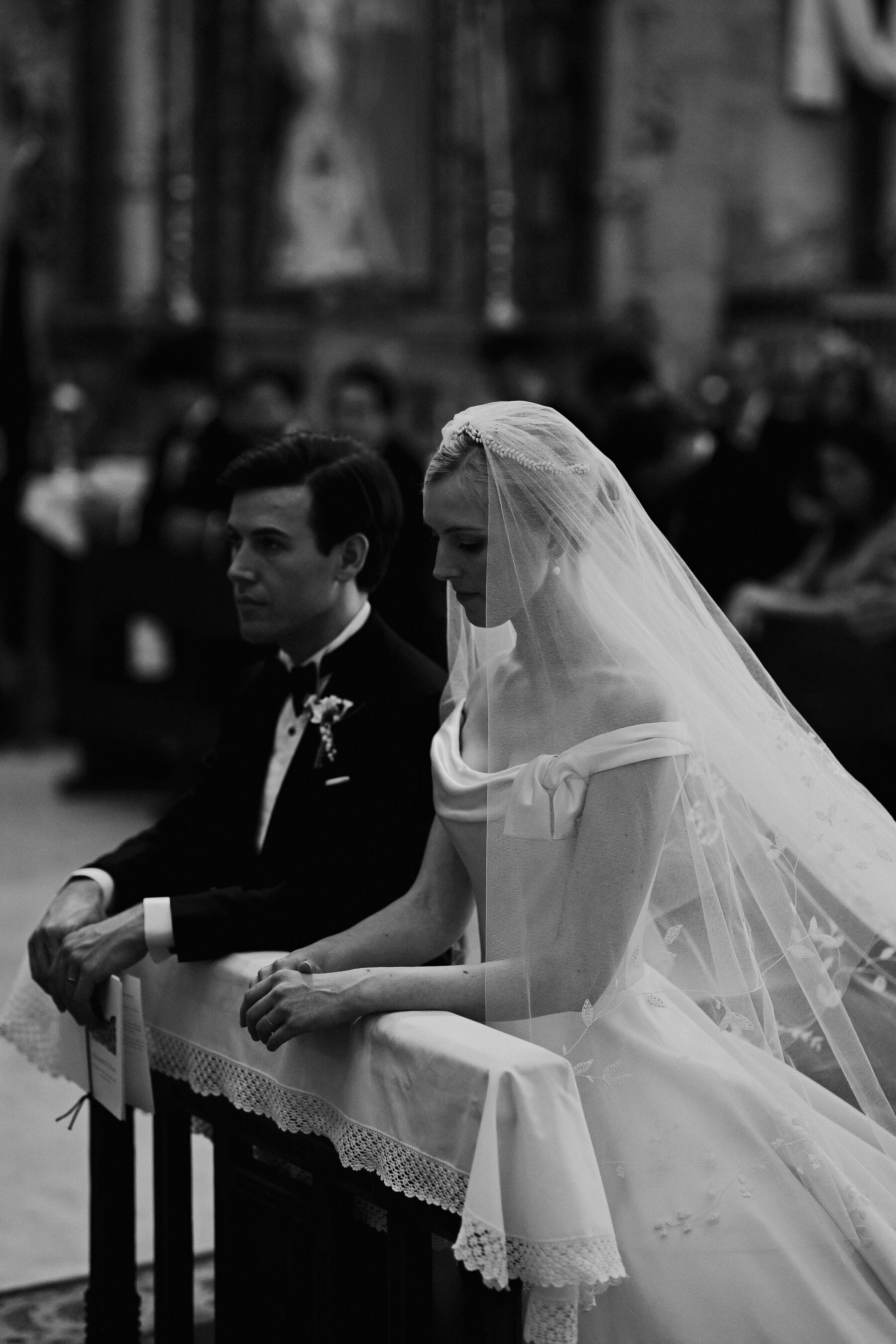 Alexandra Wore Phillipa Lepley For Her Romantic Destination Wedding in Spain 25 Bride and groom kneeling at the alter on their wedding day in Spain. She wears Phillipa Lepley - the groom is in black tie tuxedo.