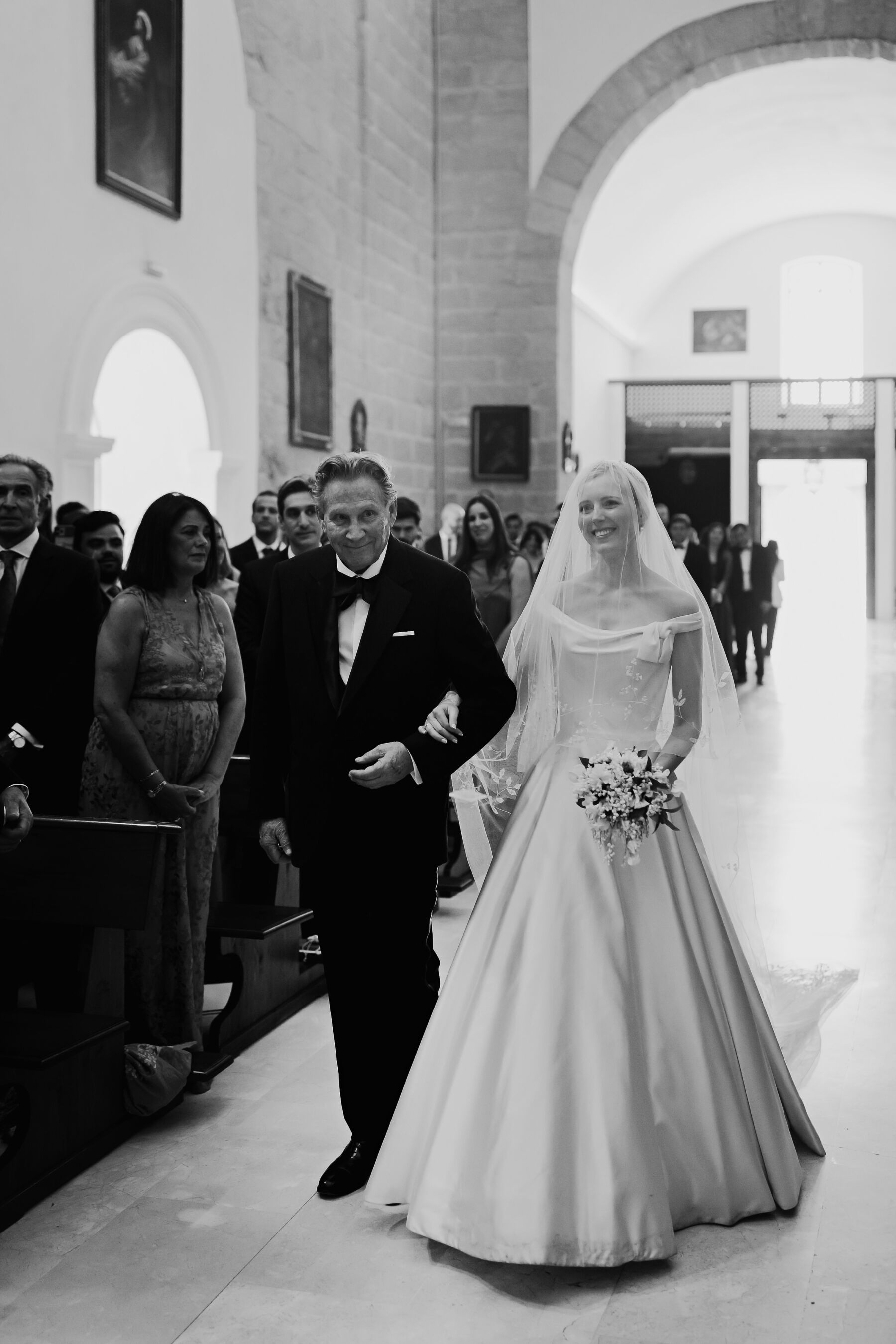 Alexandra Wore Phillipa Lepley For Her Romantic Destination Wedding in Spain 23 Elegant bride wearing Phillip Lepley walking down the aisle of the church arm in arm with her father.