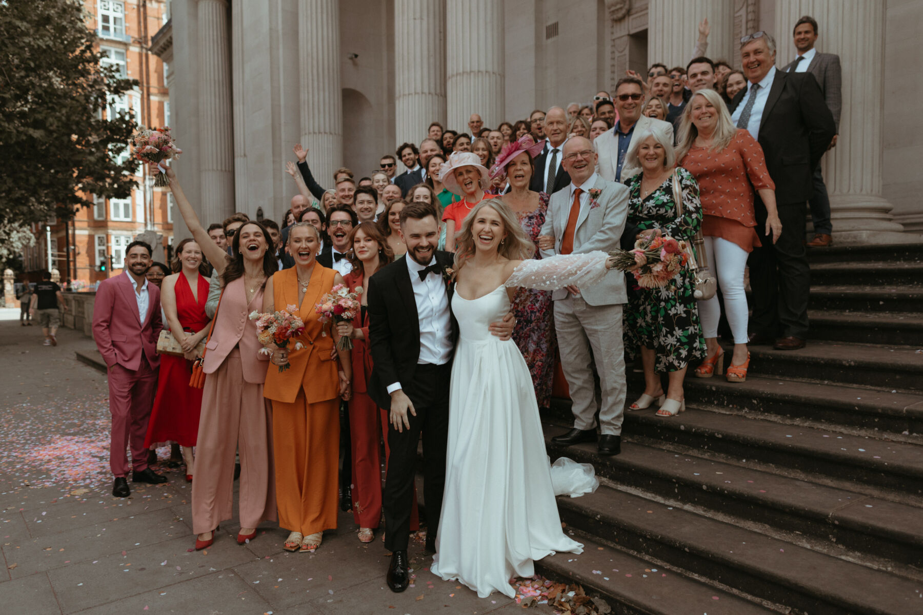 Georgia in Truvelle for her Modern London Wedding at The Depot in Islington 20 Wedding day group shot on the steps of Old Marylebone Town Hall, London.