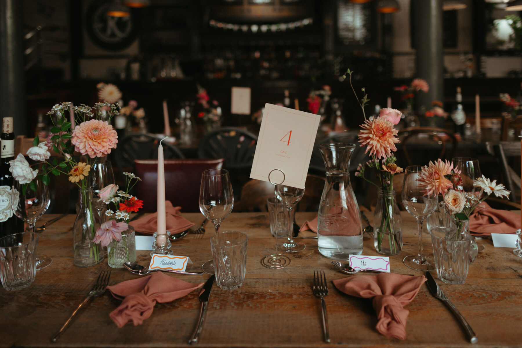 Georgia in Truvelle for her Modern London Wedding at The Depot in Islington 25 Colourful bud vases wedding table decor inside a pub.