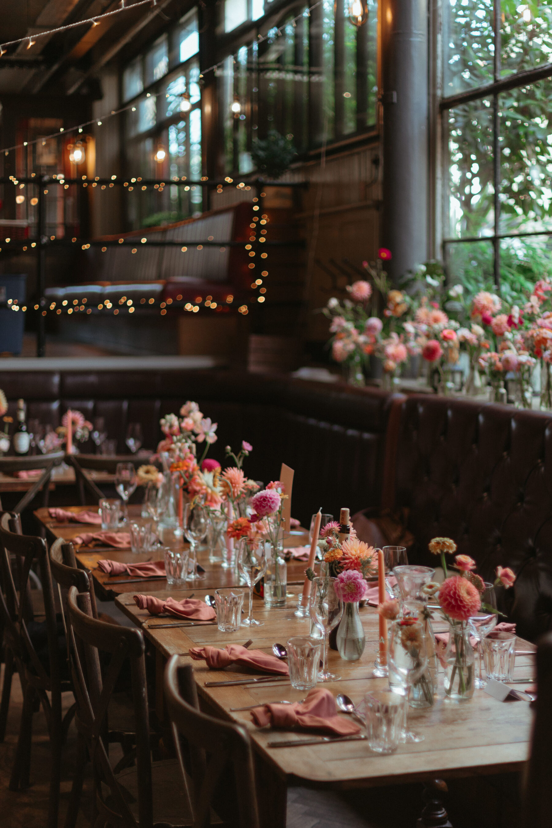 Georgia in Truvelle for her Modern London Wedding at The Depot in Islington 23 Colourful wedding flowers in bud vases for a pub wedding in London. Peach napkins.