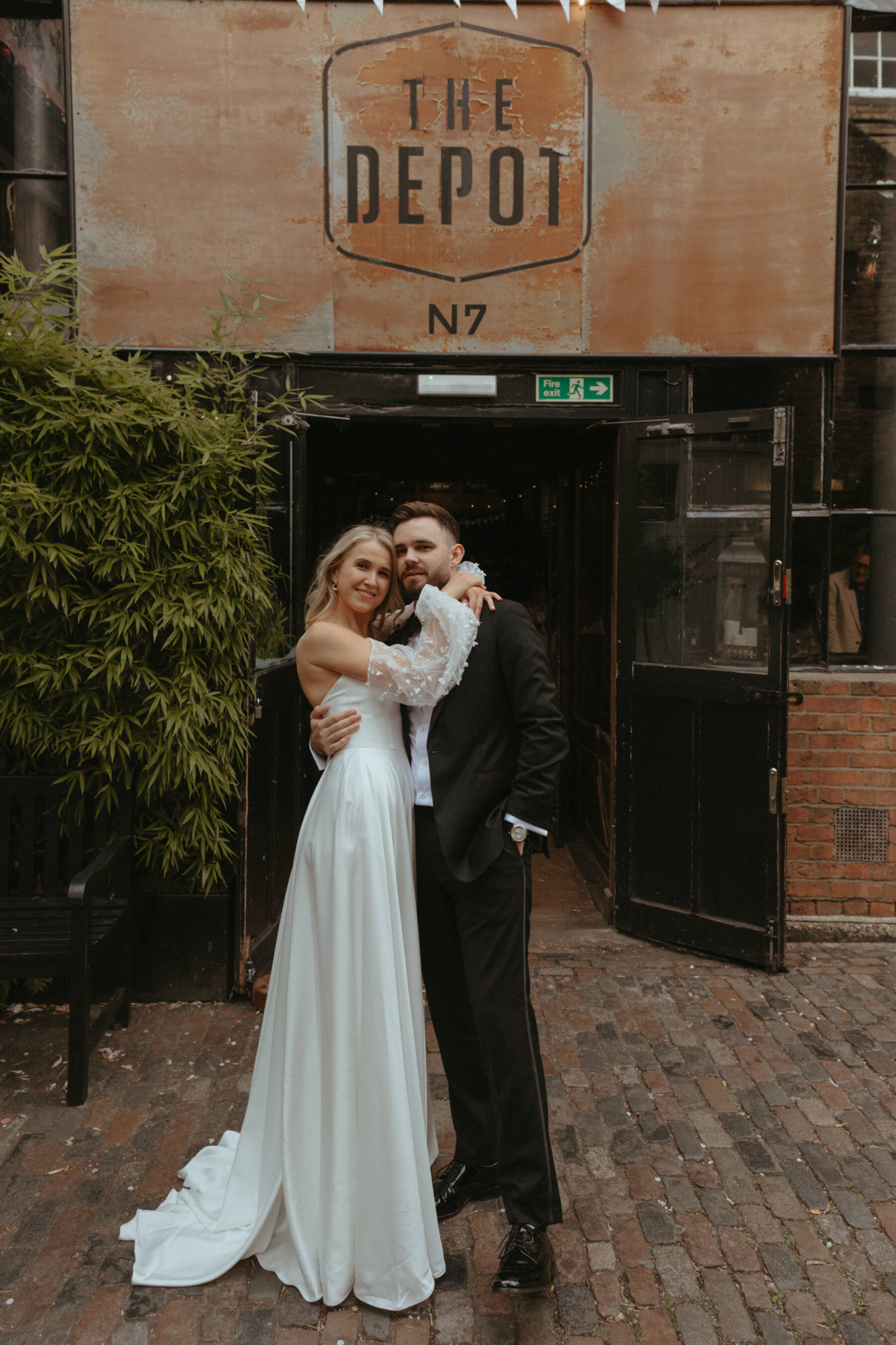 Georgia in Truvelle for her Modern London Wedding at The Depot in Islington 22 Bride wearing Truvelle, standing outside The Depot pub in London.